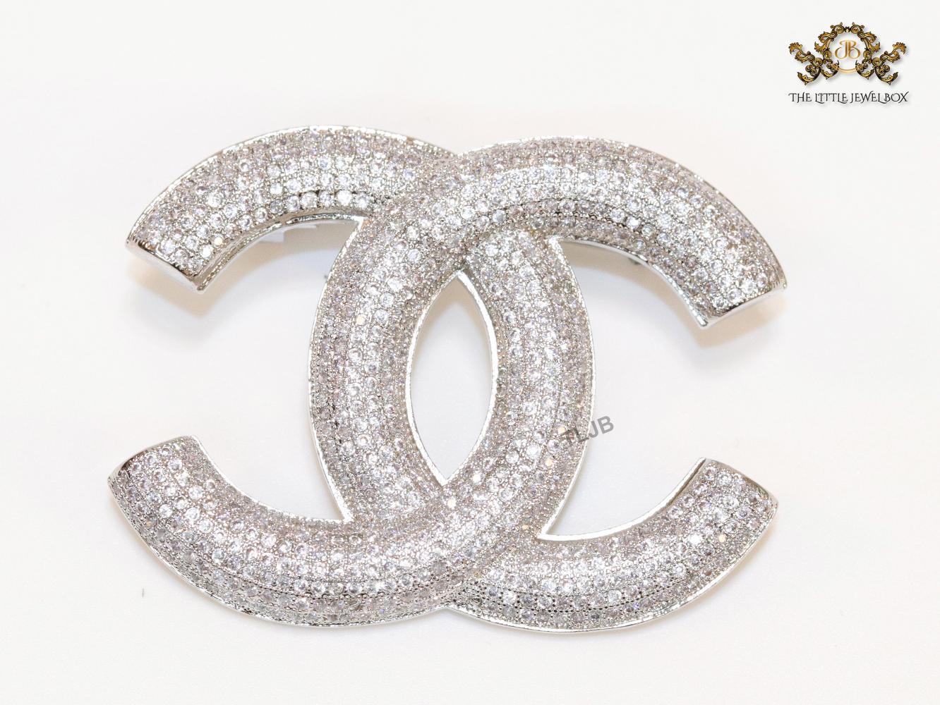 Platinum plated double C alphabet brooch with tiny cubic zirconia stones