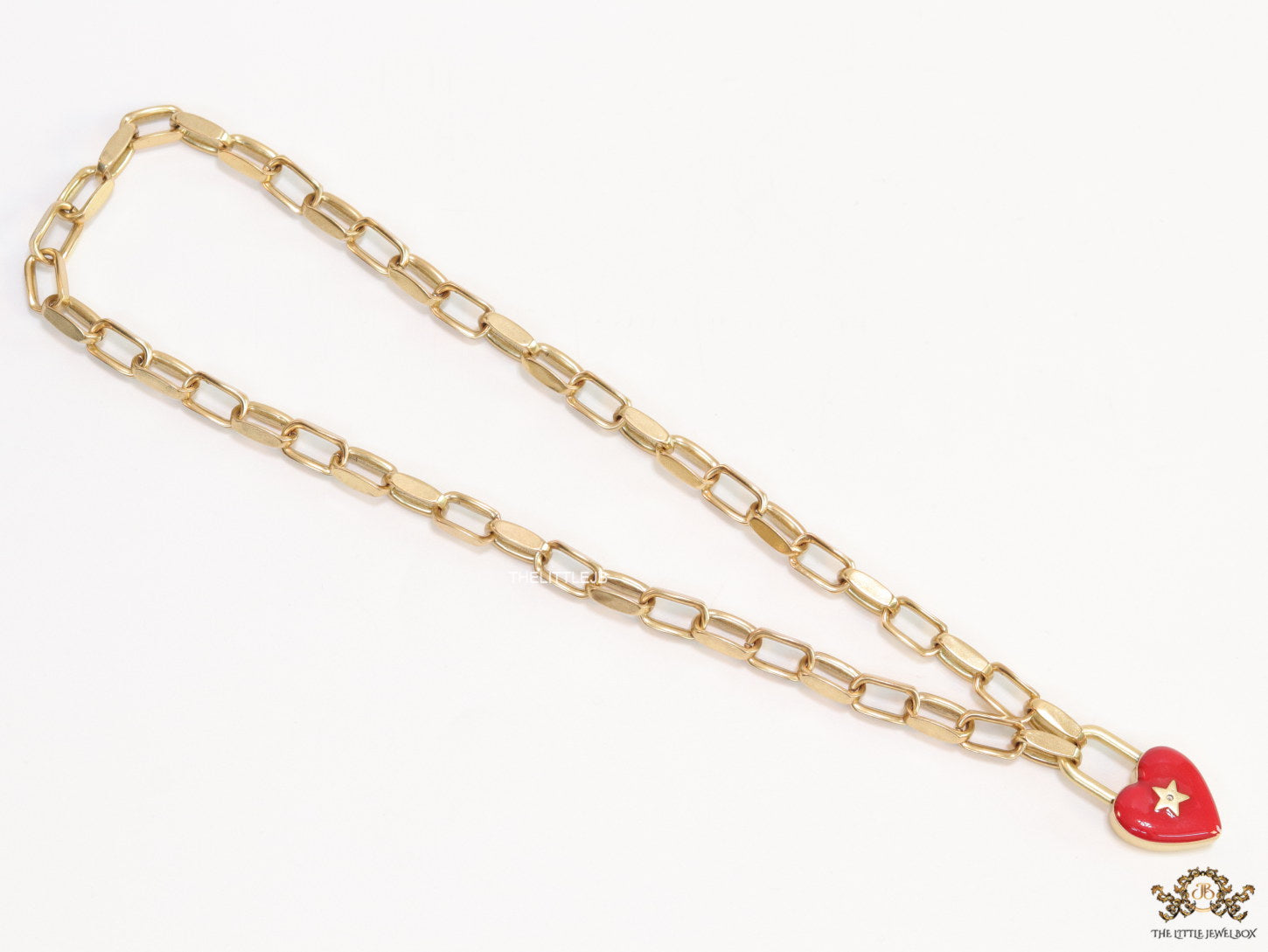 Golden link chain necklace with heart shape lock pendant