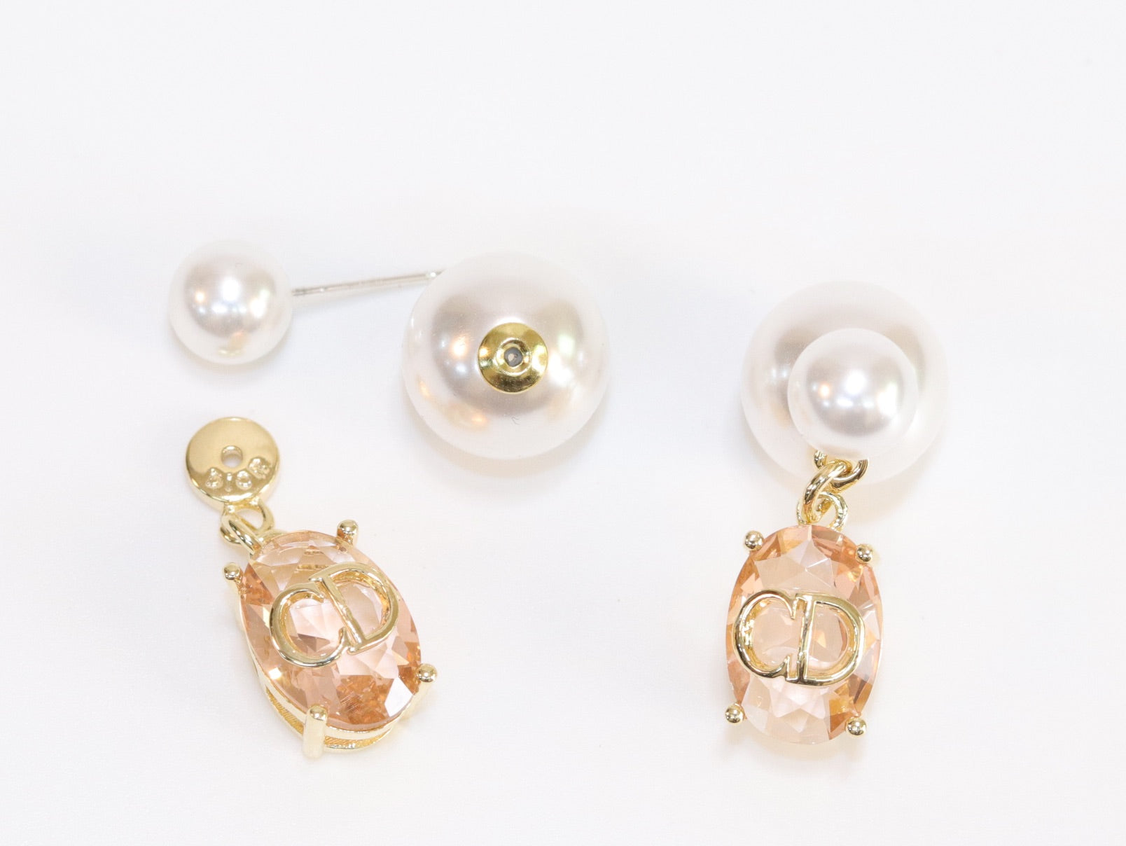 Alphabet C and D dangling baby pink stone pearl studs in rose gold finish