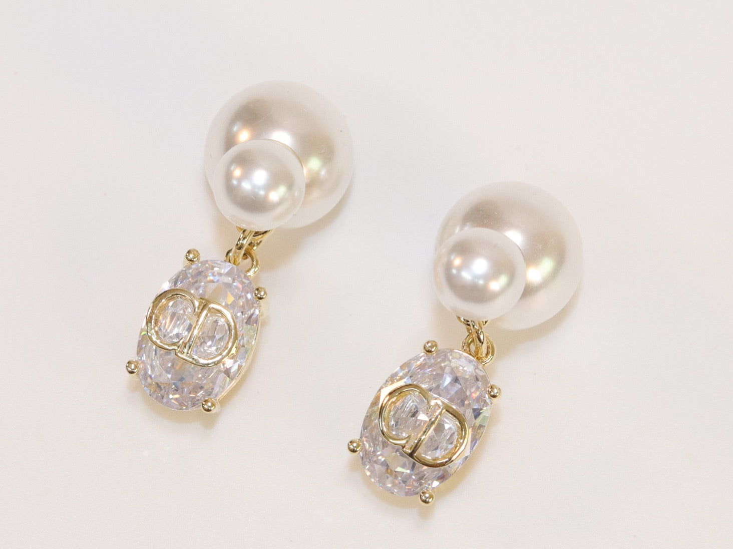 Alphabet C and D dangling stone pearl studs in platinum finish