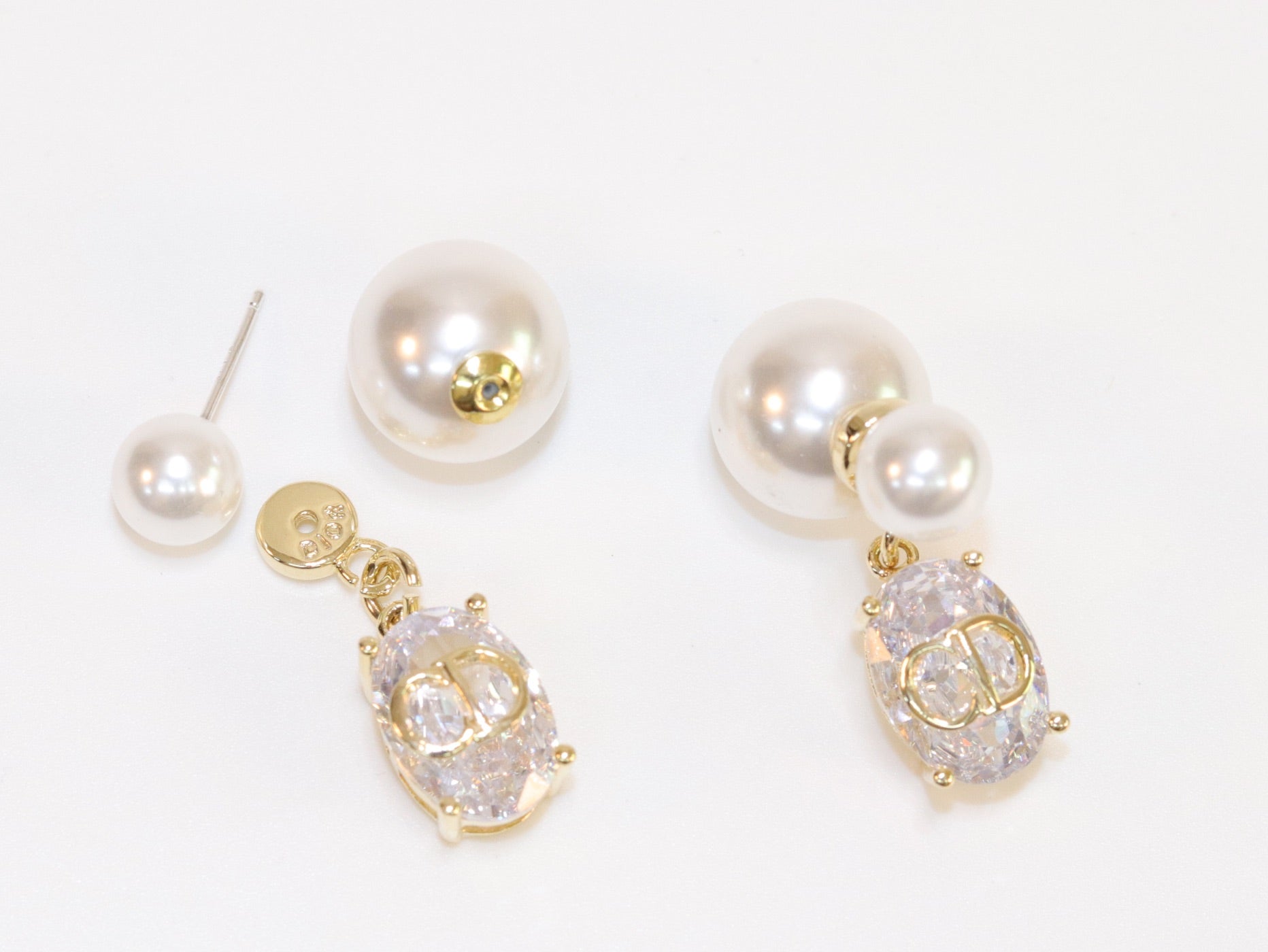 Alphabet C and D dangling stone pearl studs in platinum finish