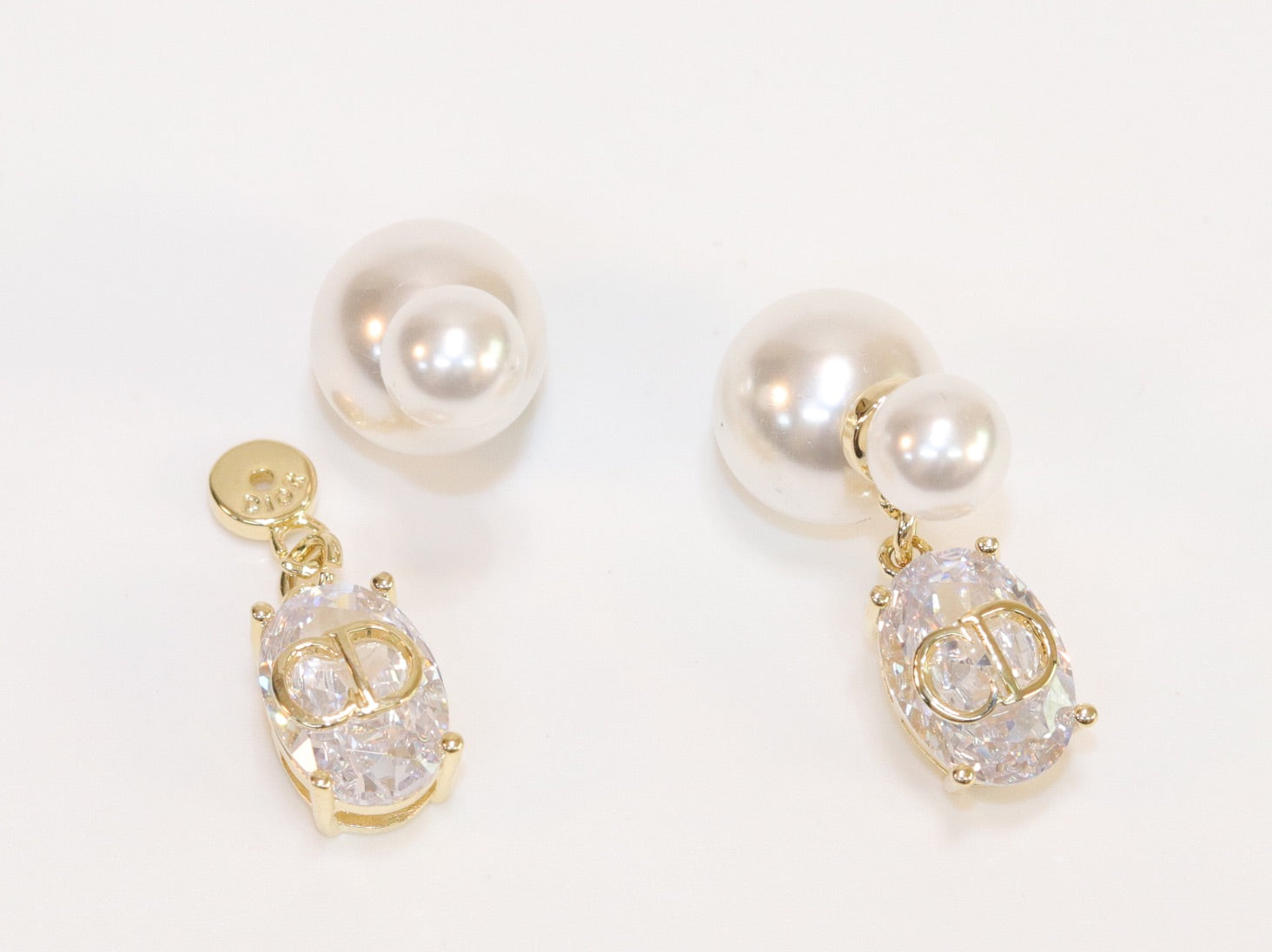 Alphabet C and D dangling stone pearl studs in platinum finish