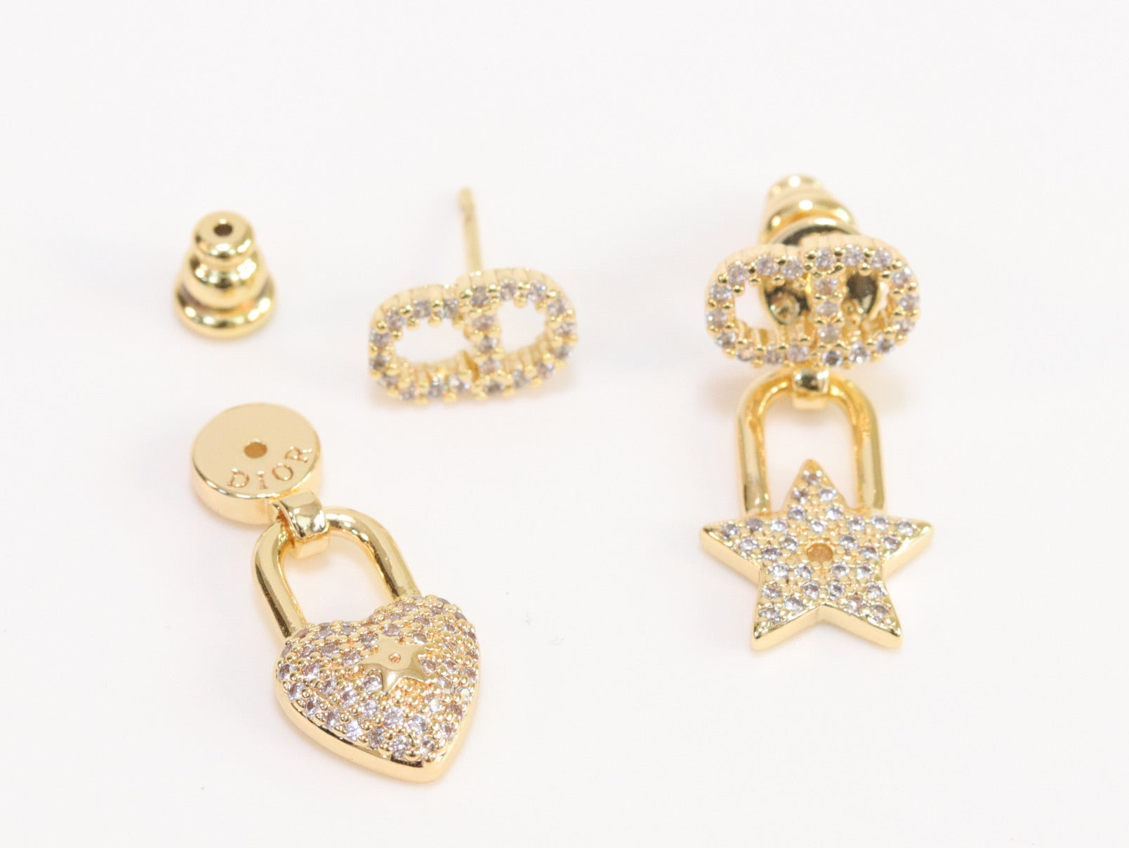 Alphabet C and D lock and star dangling stud in gold finish with cz