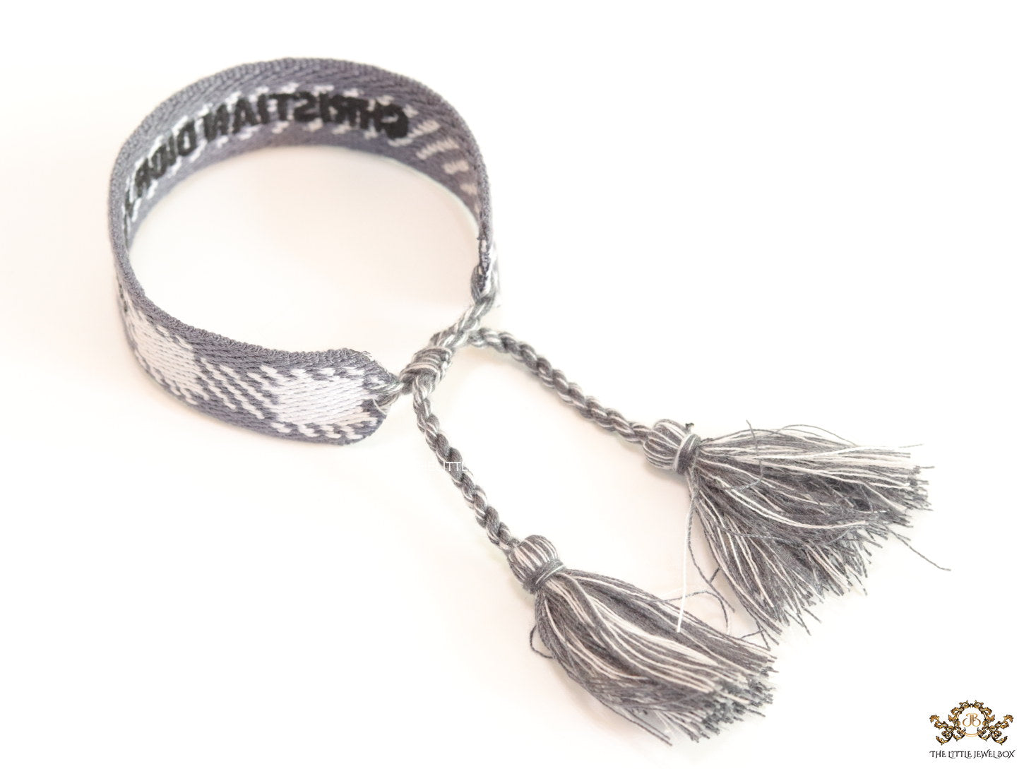 Woven grey bracelet band with black knitted alphabets