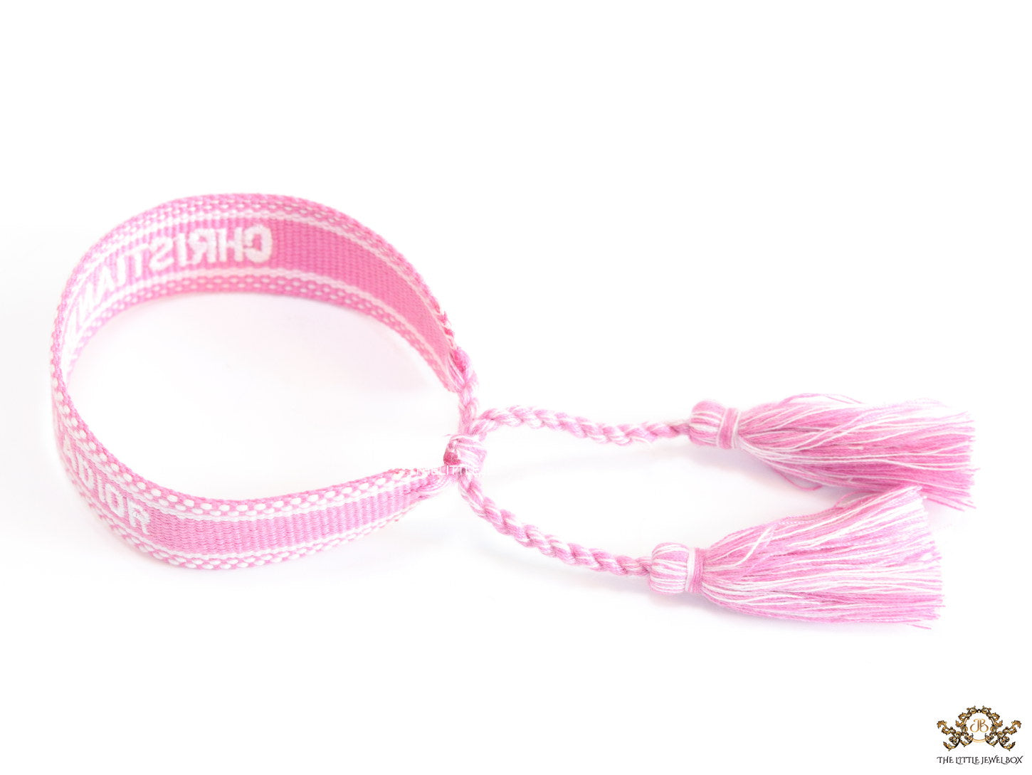 Adjustable pink woven bracelet with white knitted alphabets and tassels