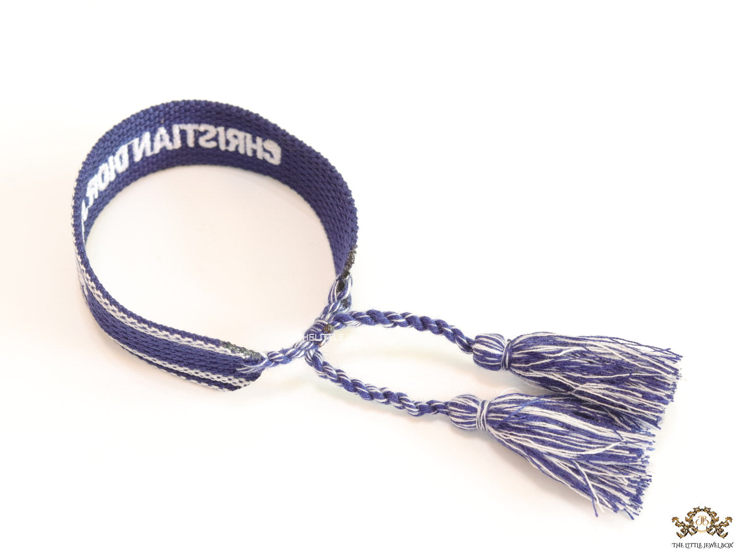 Adjustable blue woven bracelet with white knitted alphabets and tassels