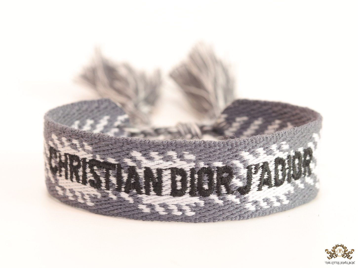 Woven grey bracelet band with black knitted alphabets