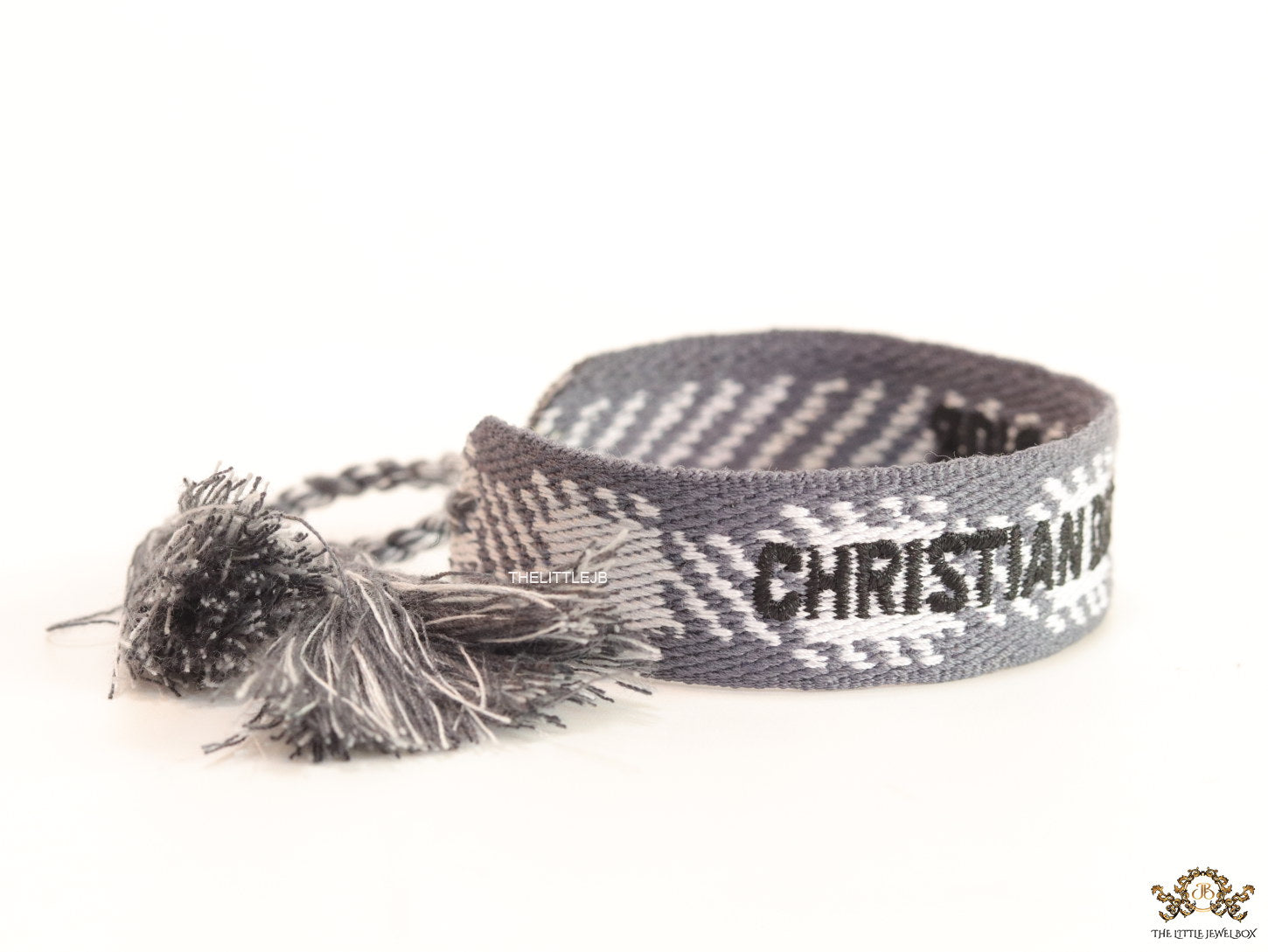 Woven grey bracelet band with black knitted alphabets