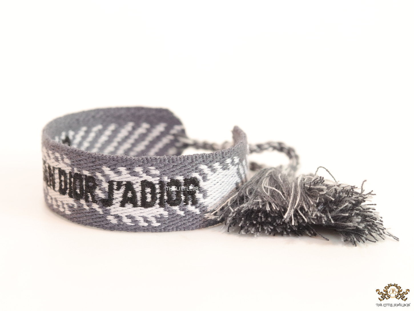 Woven grey bracelet band with black knitted alphabets