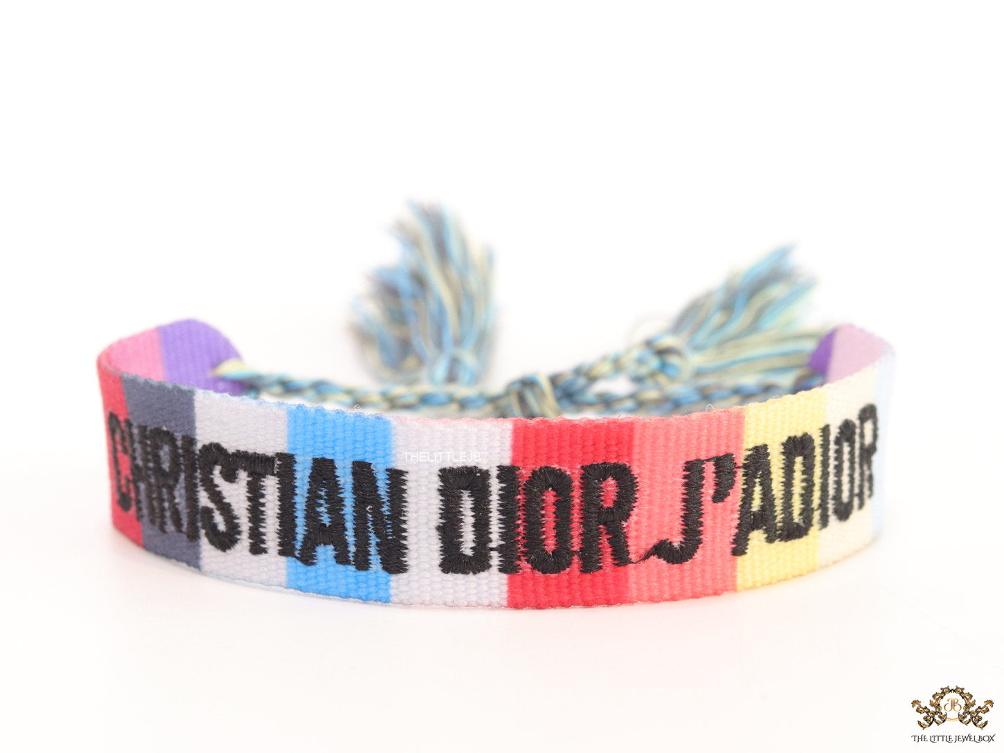 Adjustable multi color woven bracelet with black knitted alphabets and tassels