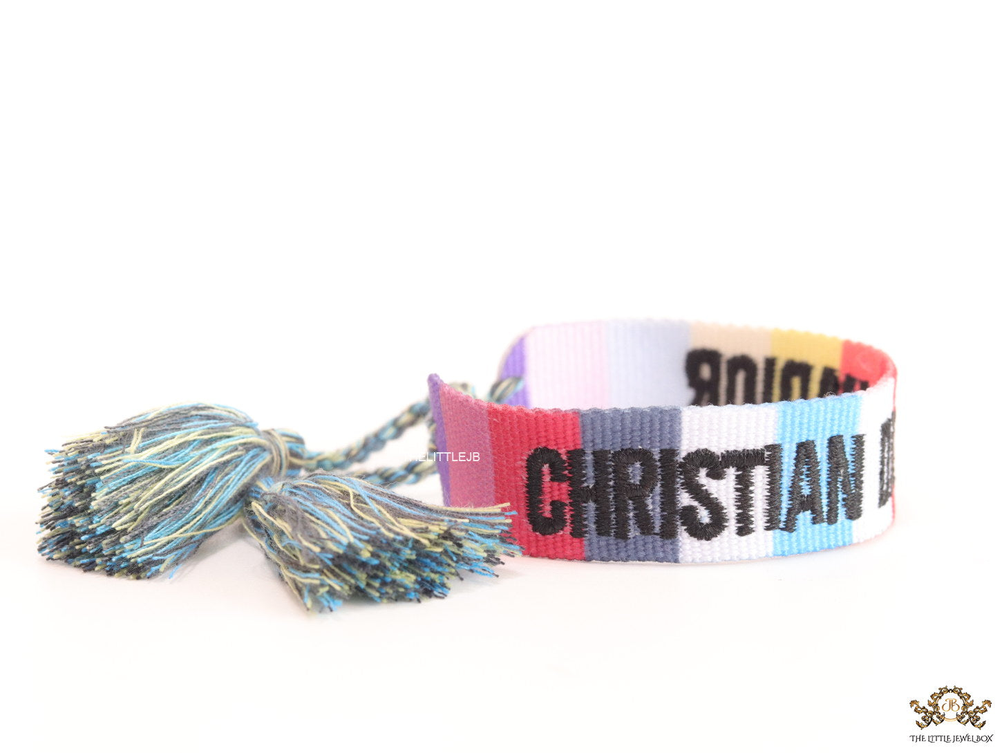 Adjustable multi color woven bracelet with black knitted alphabets and tassels