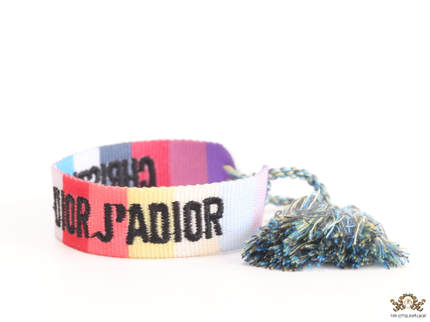 Adjustable multi color woven bracelet with black knitted alphabets and tassels