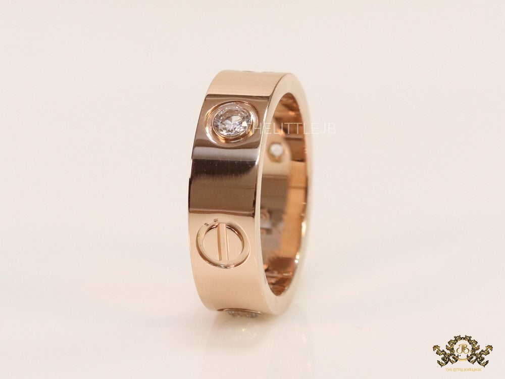 Broad 6mm rose gold band with screws and stones