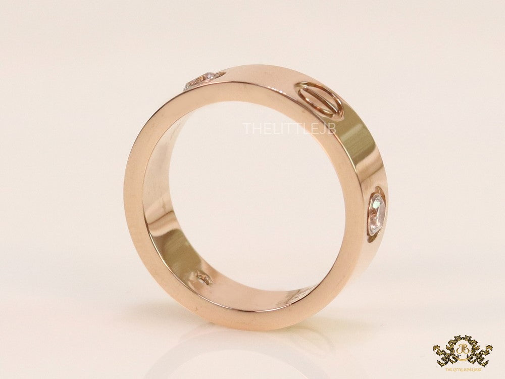 Broad 6mm rose gold band with screws and stones