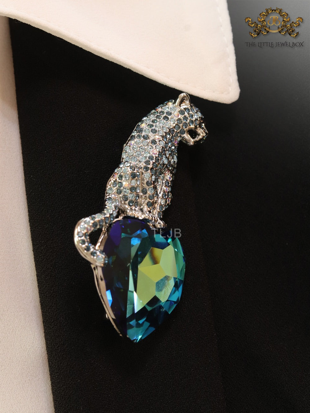 Inverted panther on heart-shaped London blue topaz brooch