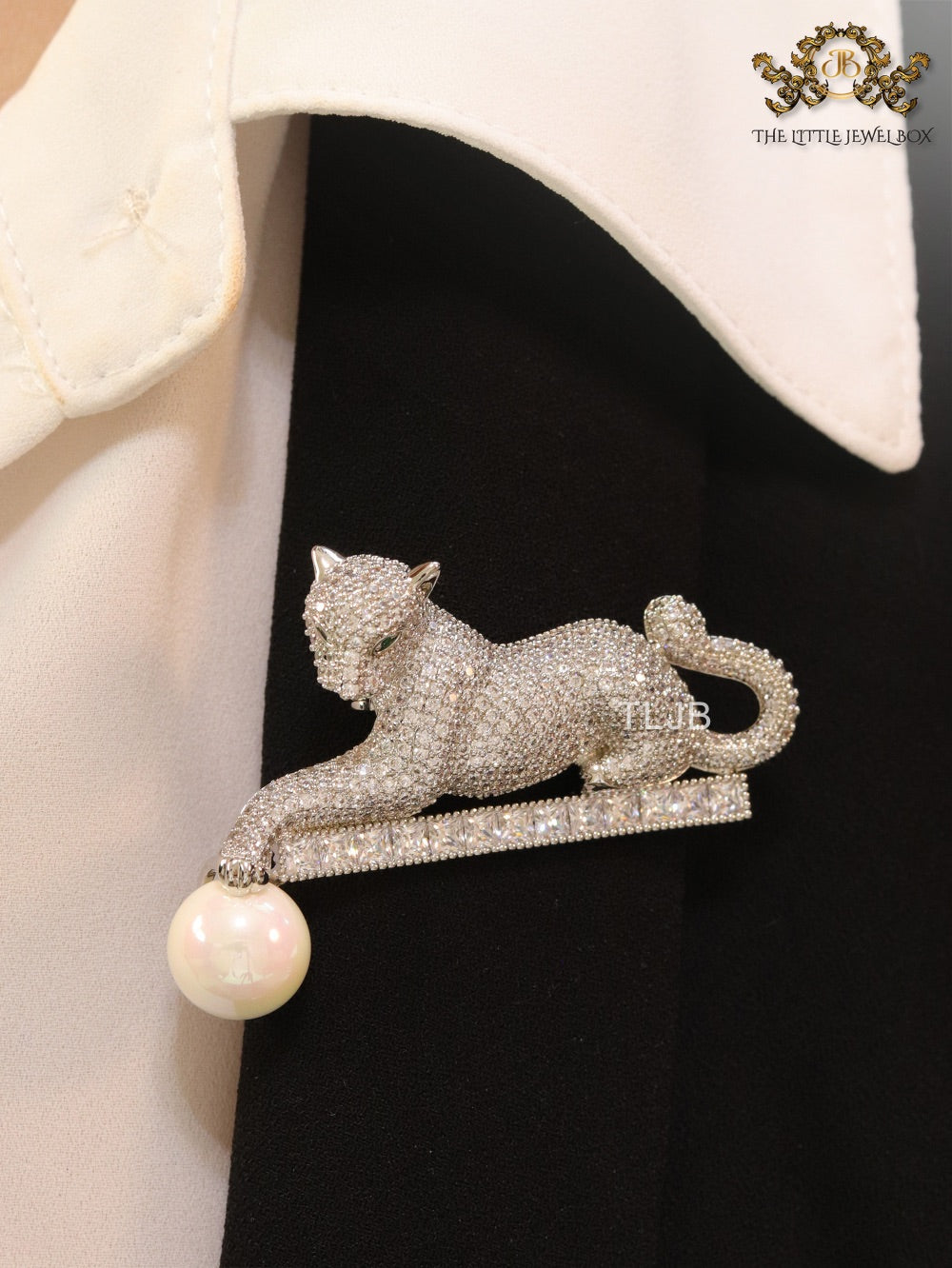 Platinum panther with white pearl, cz and emerald stones brooch