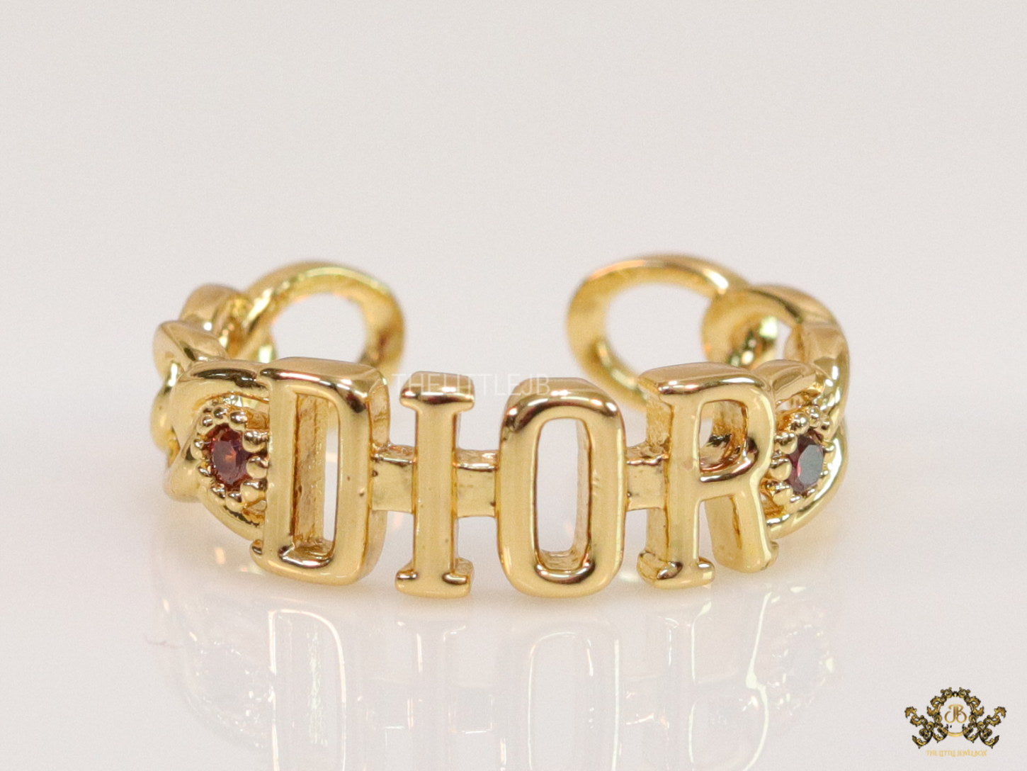 Gold plated alphabet open ring with orange cz