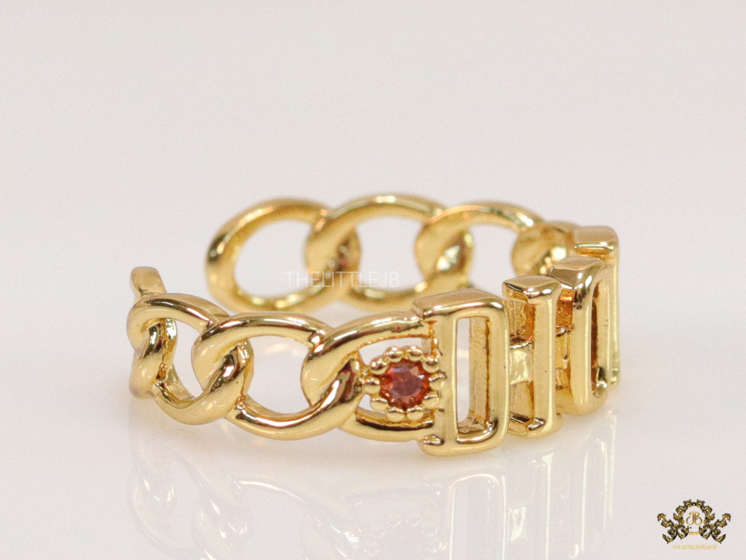 Gold plated alphabet open ring with orange cz
