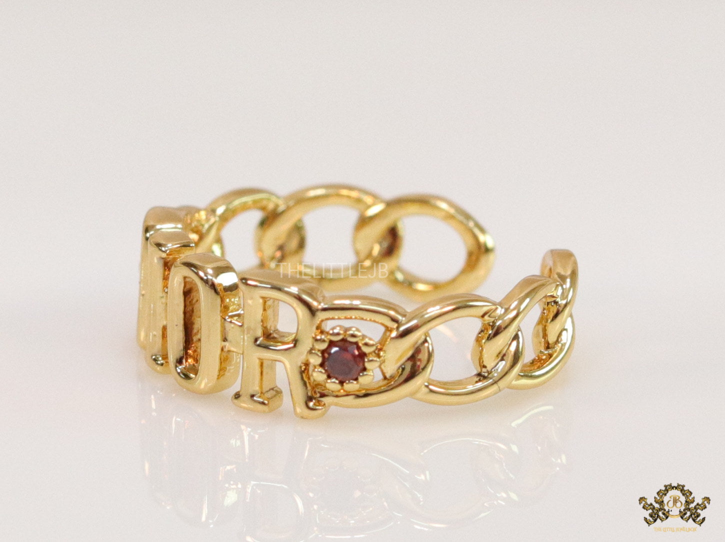 Gold plated alphabet open ring with orange cz