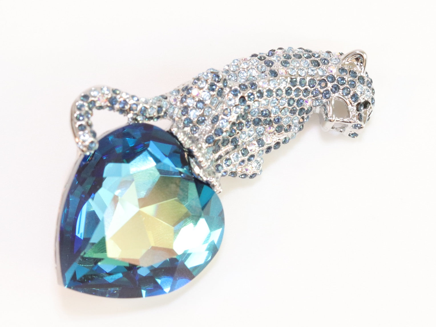 Inverted panther on heart-shaped London blue topaz brooch