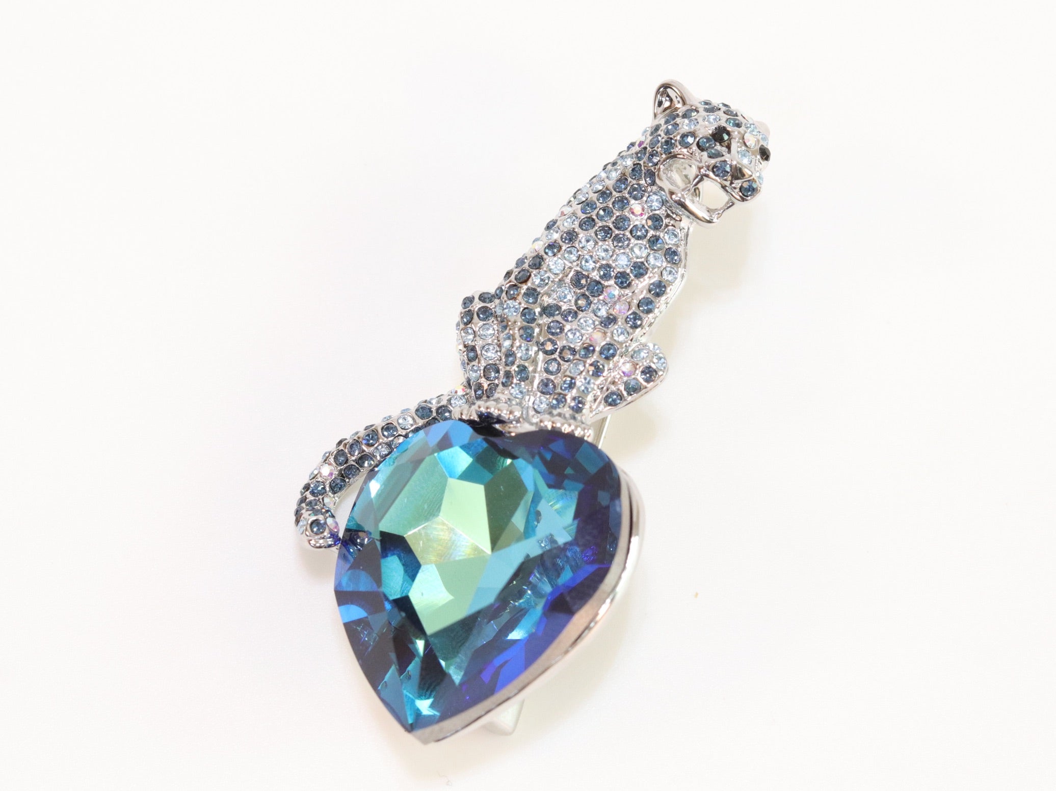 Inverted panther on heart-shaped London blue topaz brooch
