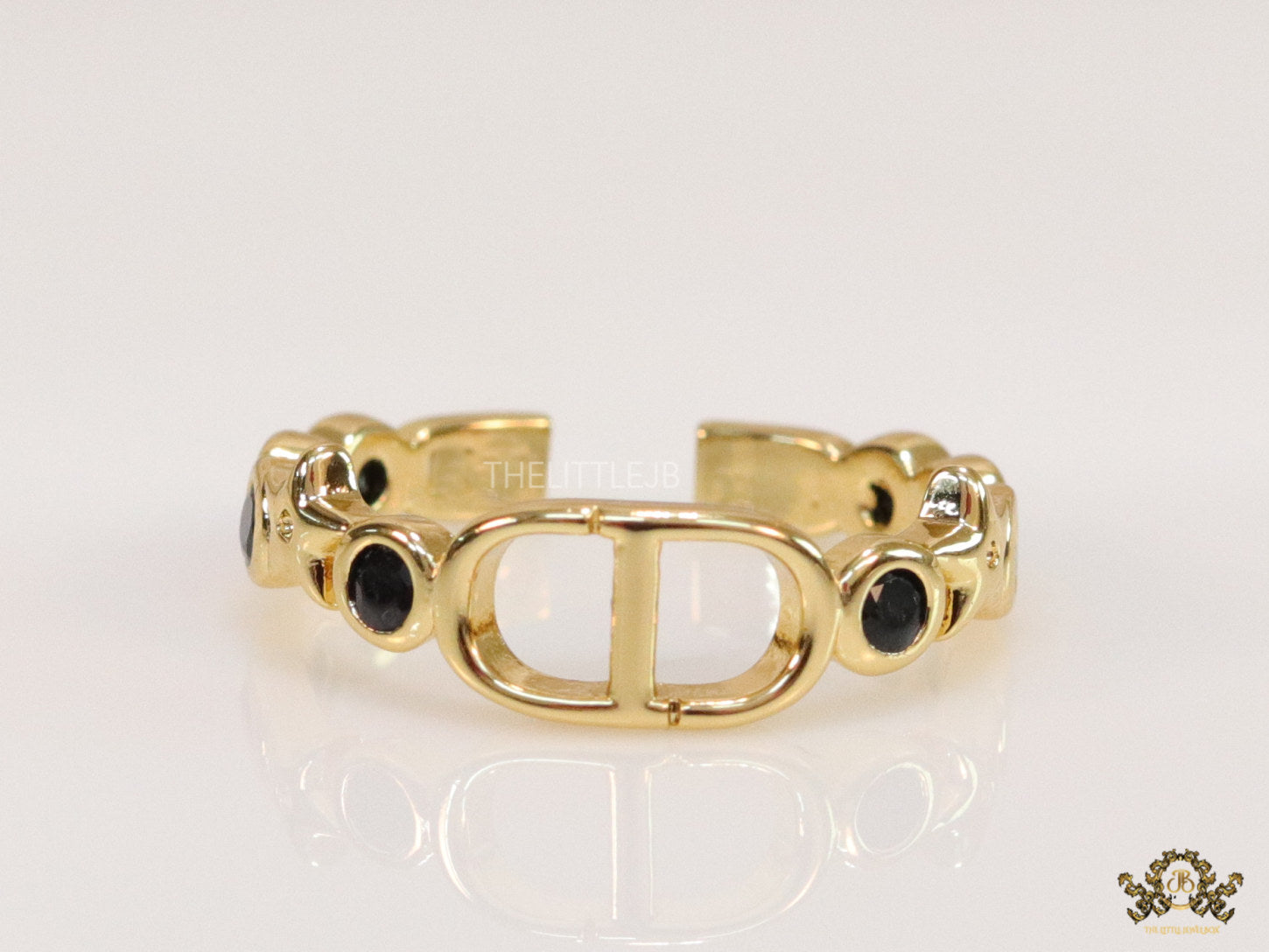 Gold finish alphabet open ring with black cz
