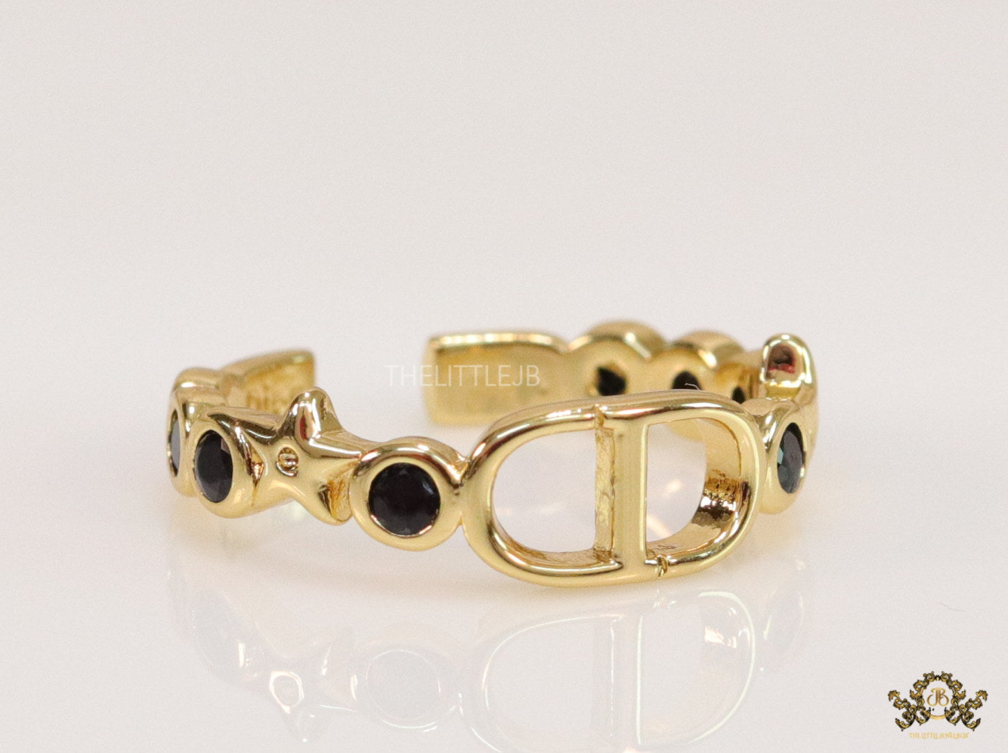 Gold finish alphabet open ring with black cz