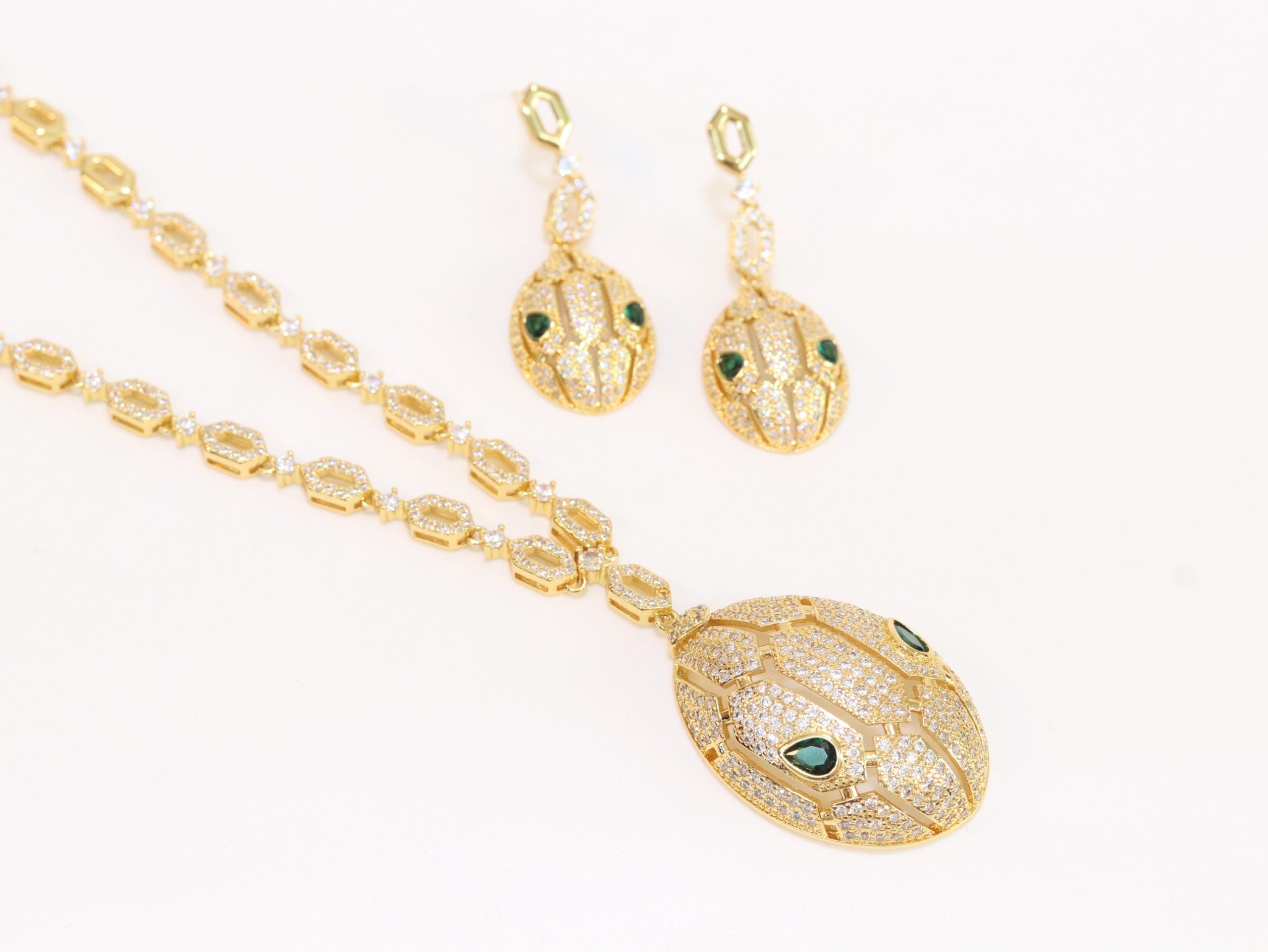 Gold Snake head pendant set with emerald detailing