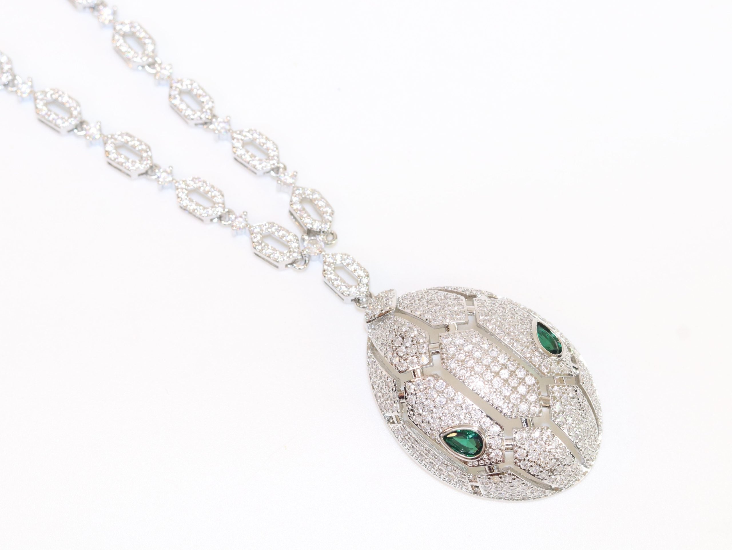 Platinum Snake head pendant set with emerald detailing