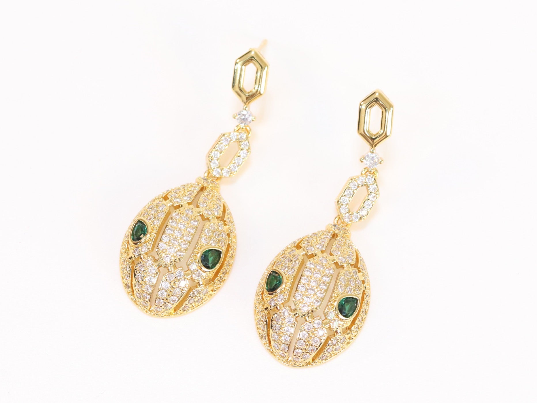 Gold Snake head pendant set with emerald detailing