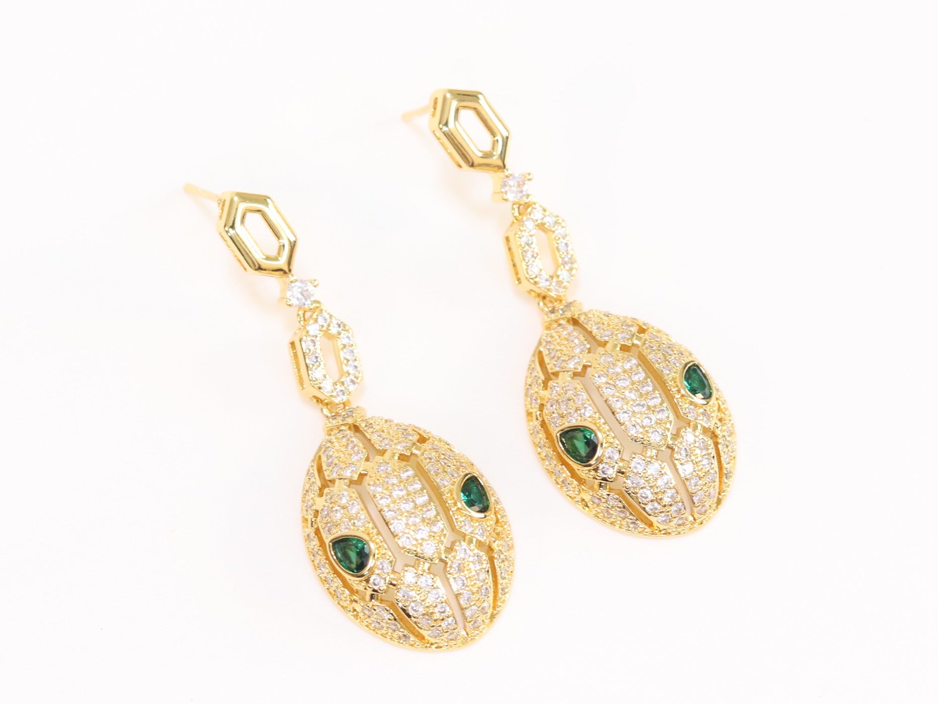 Gold Snake head pendant set with emerald detailing