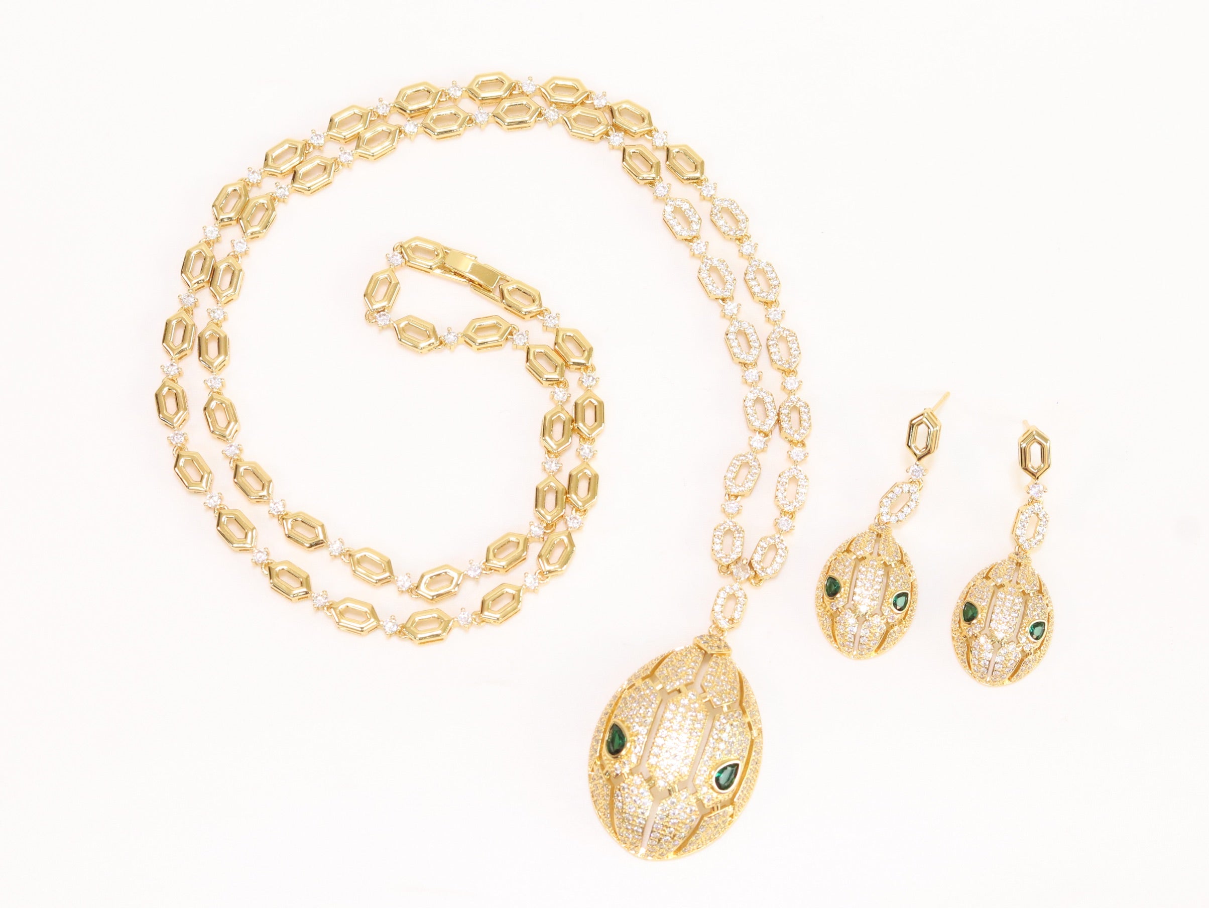 Gold Snake head pendant set with emerald detailing