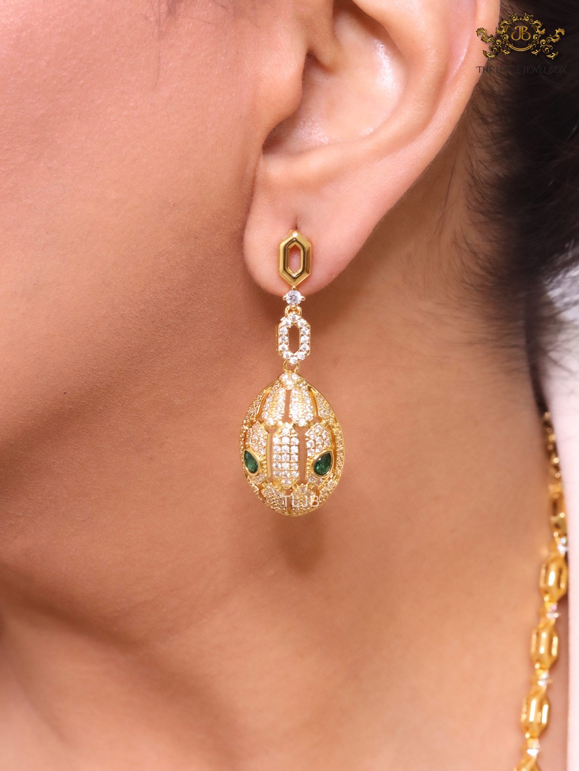 Gold Snake head pendant set with emerald detailing