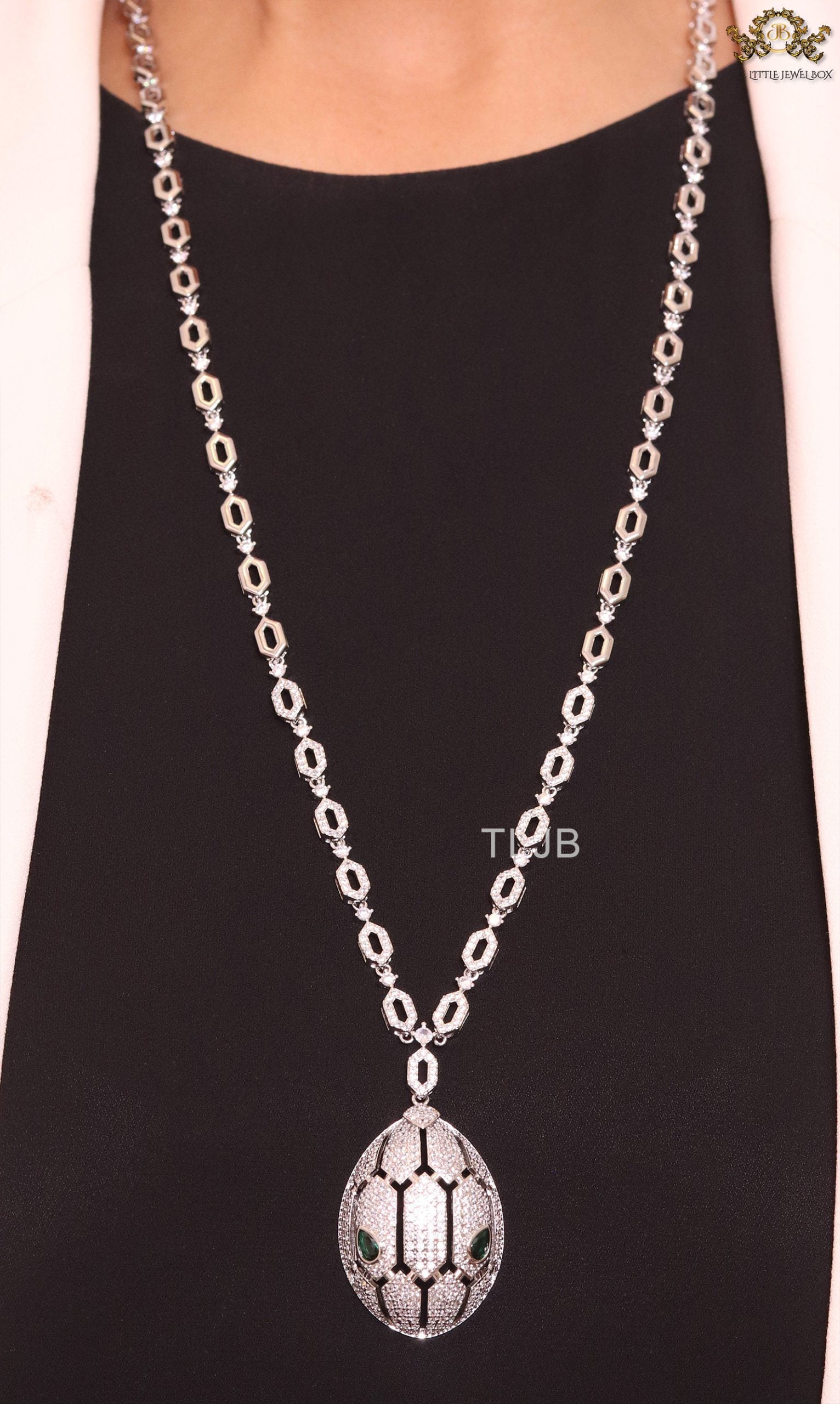 Platinum Snake head pendant set with emerald detailing
