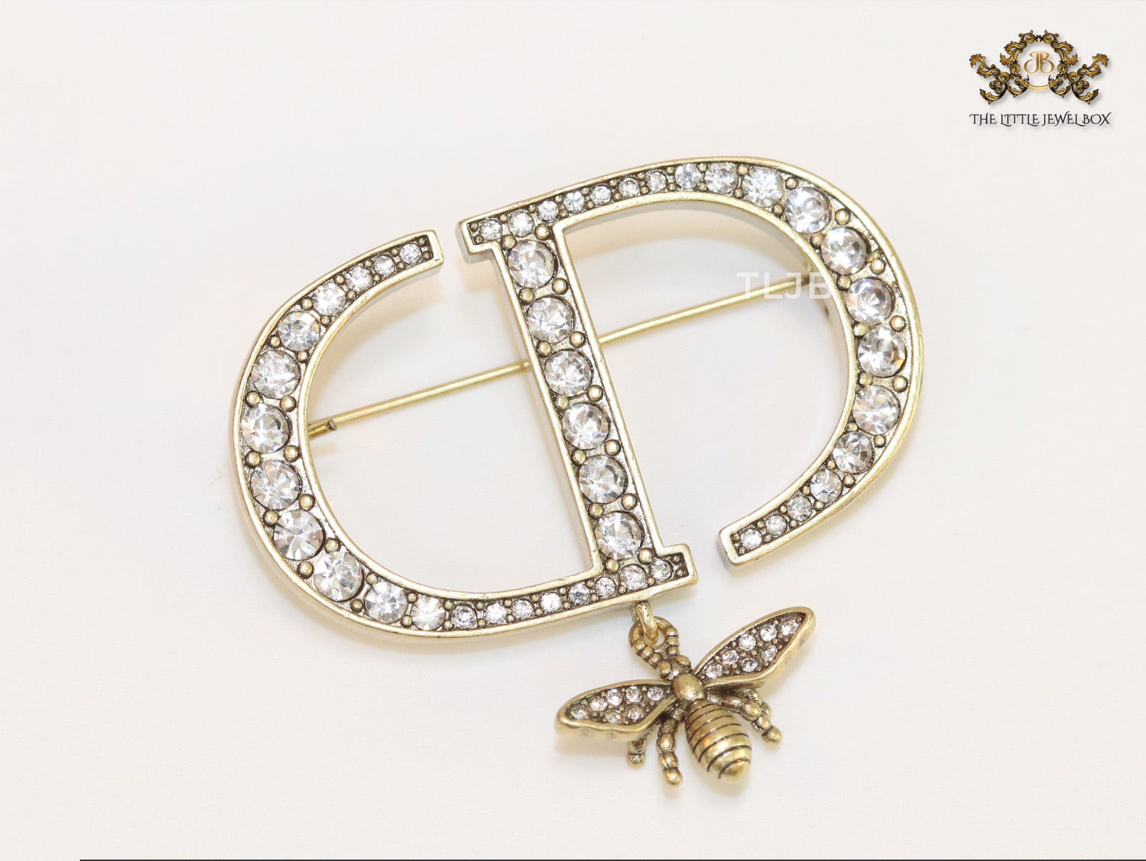 Alphabet C and D brooch in gold finish with dragonfly and cz