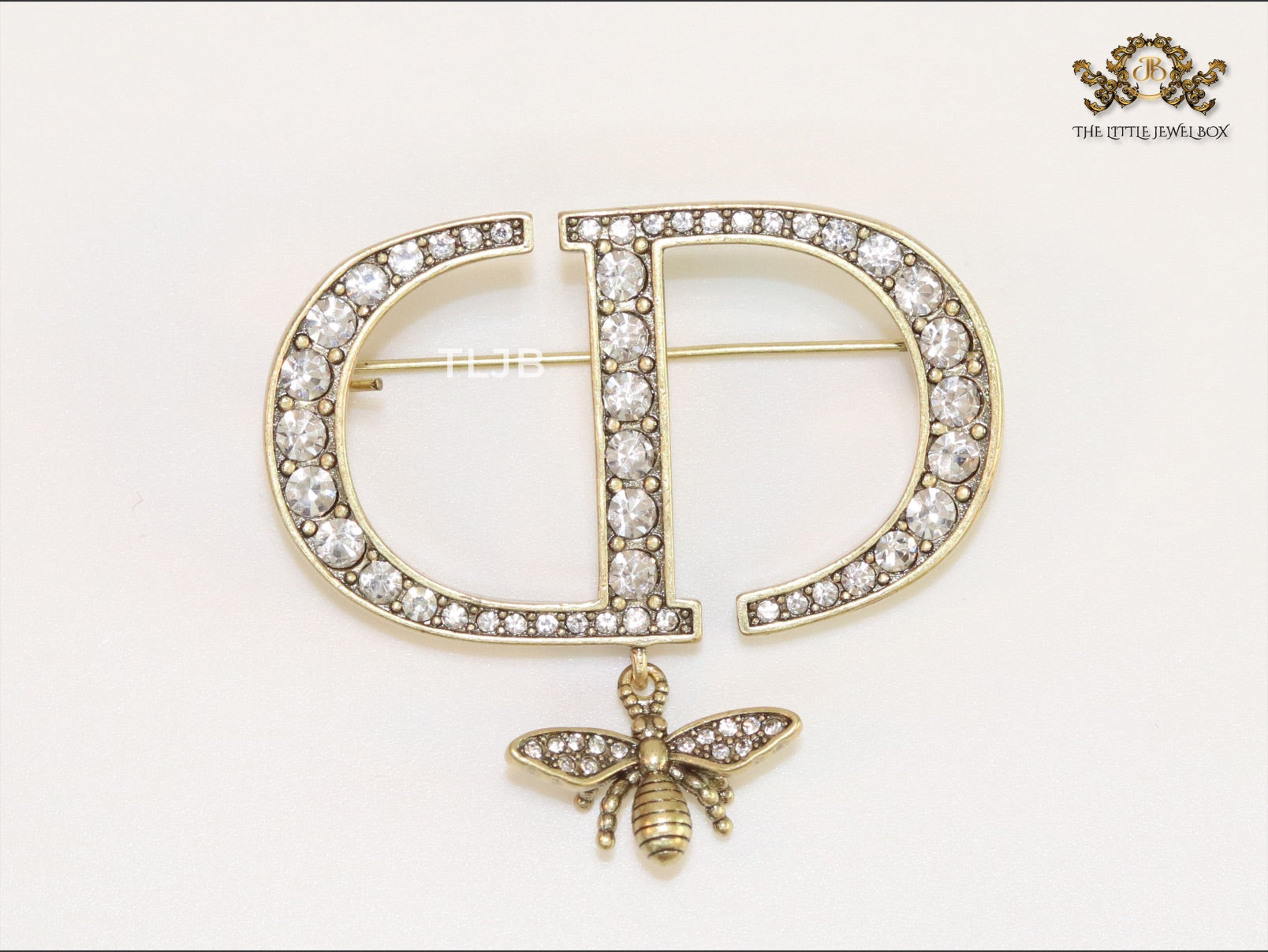 Alphabet C and D brooch in gold finish with dragonfly and cz