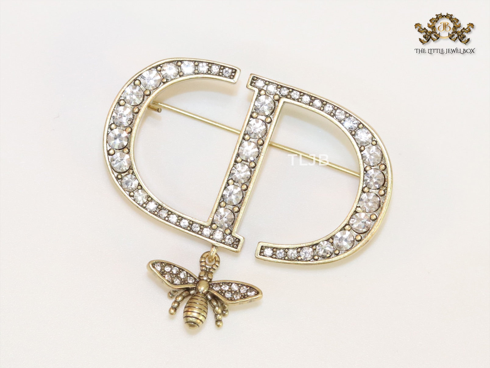 Alphabet C and D brooch in gold finish with dragonfly and cz
