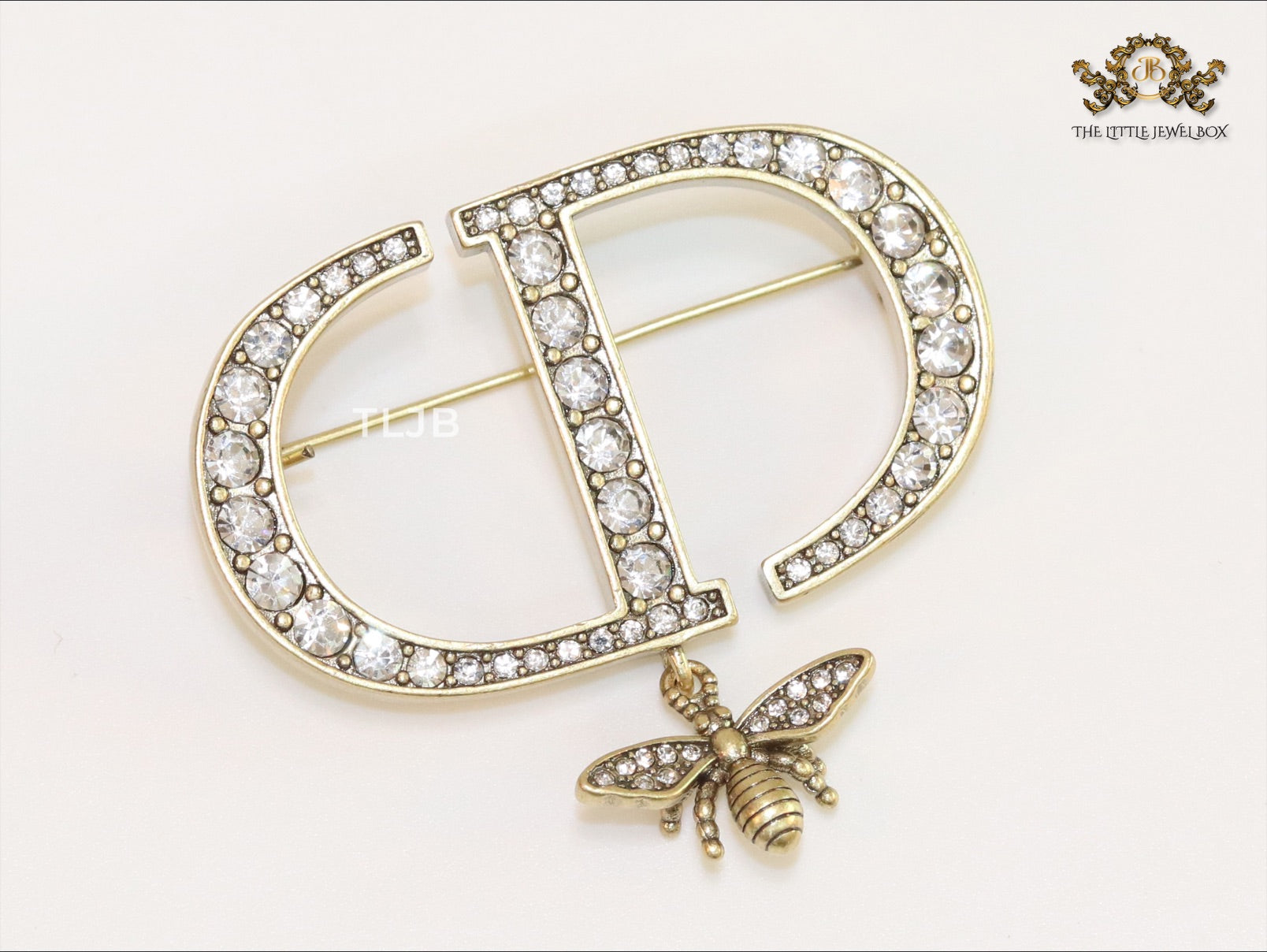 Alphabet C and D brooch in gold finish with dragonfly and cz