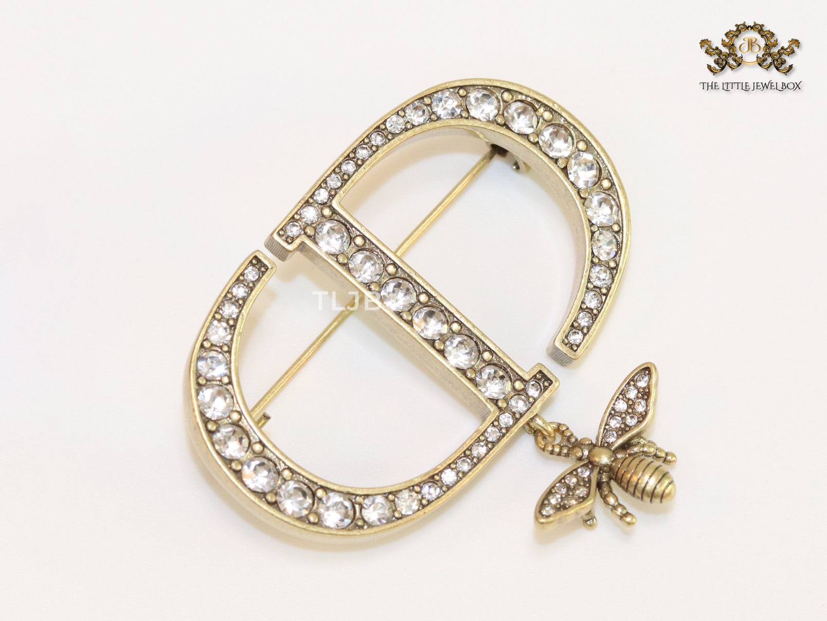 Alphabet C and D brooch in gold finish with dragonfly and cz