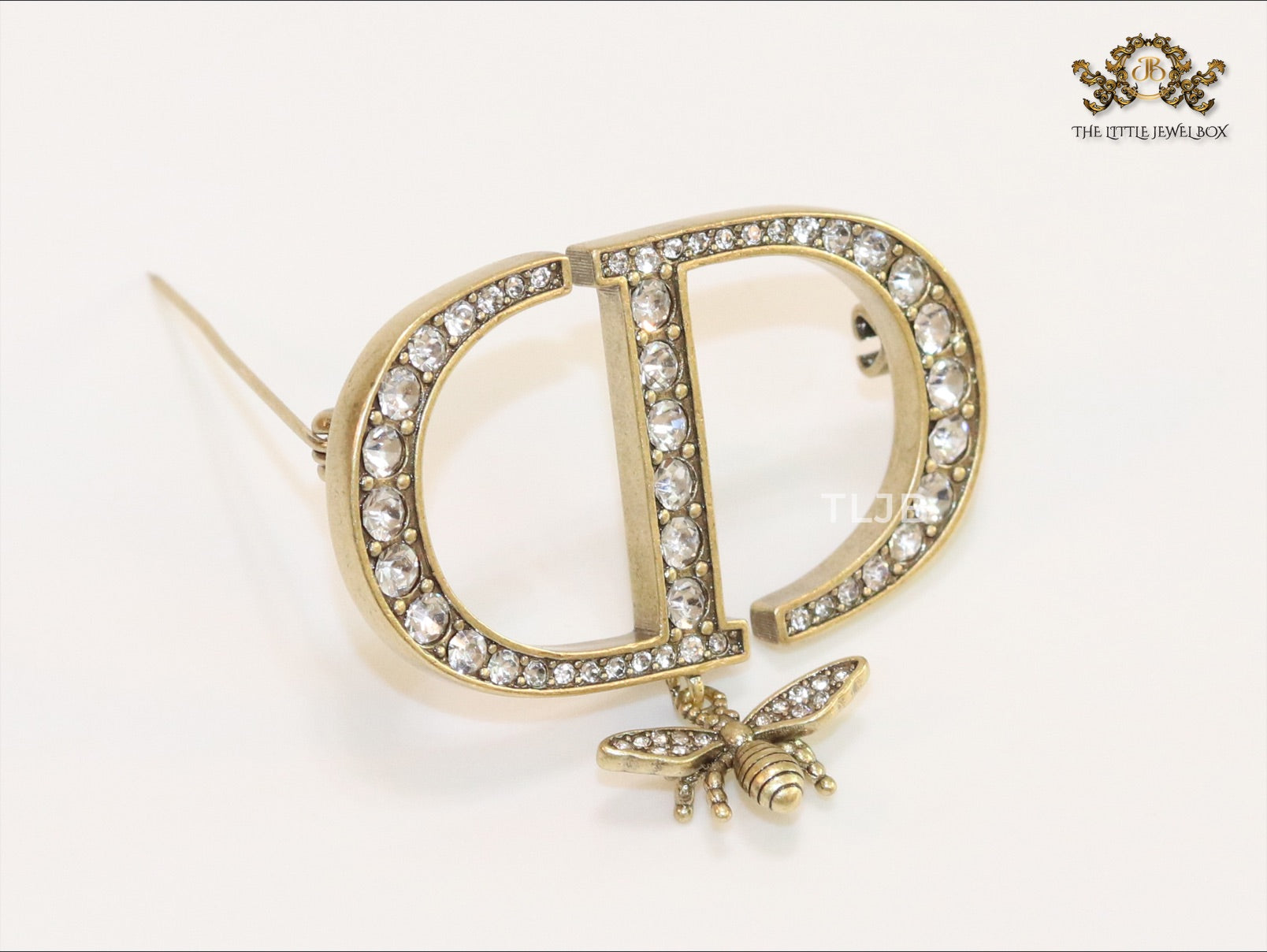Alphabet C and D brooch in gold finish with dragonfly and cz