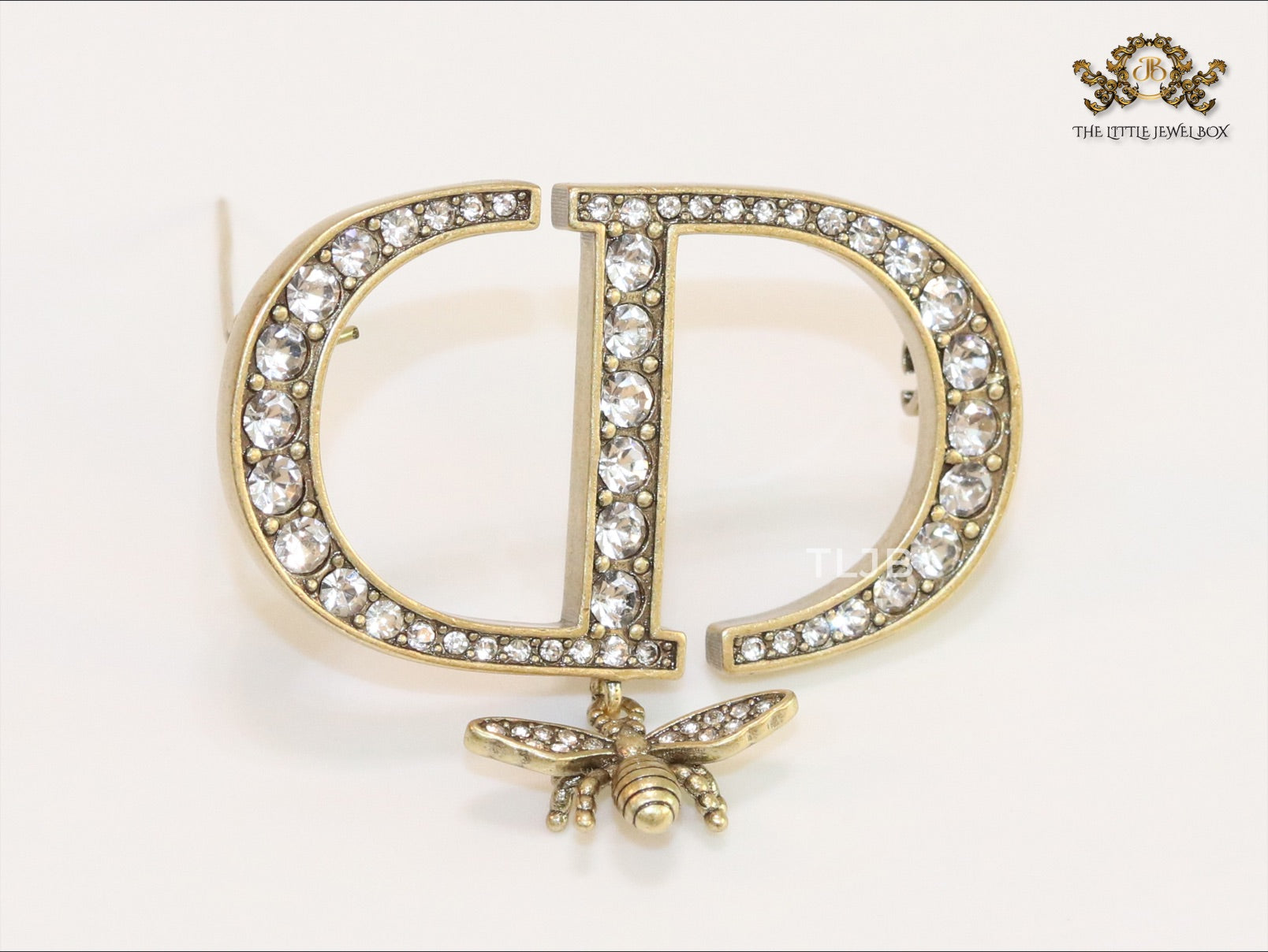 Alphabet C and D brooch in gold finish with dragonfly and cz