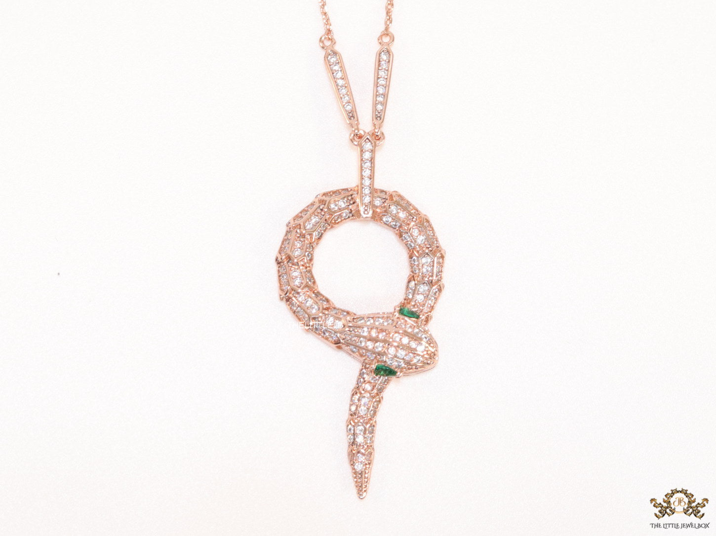 Sleek rose gold plated chain with gold plated cubic zirconia ancient serpentine symbol pendant