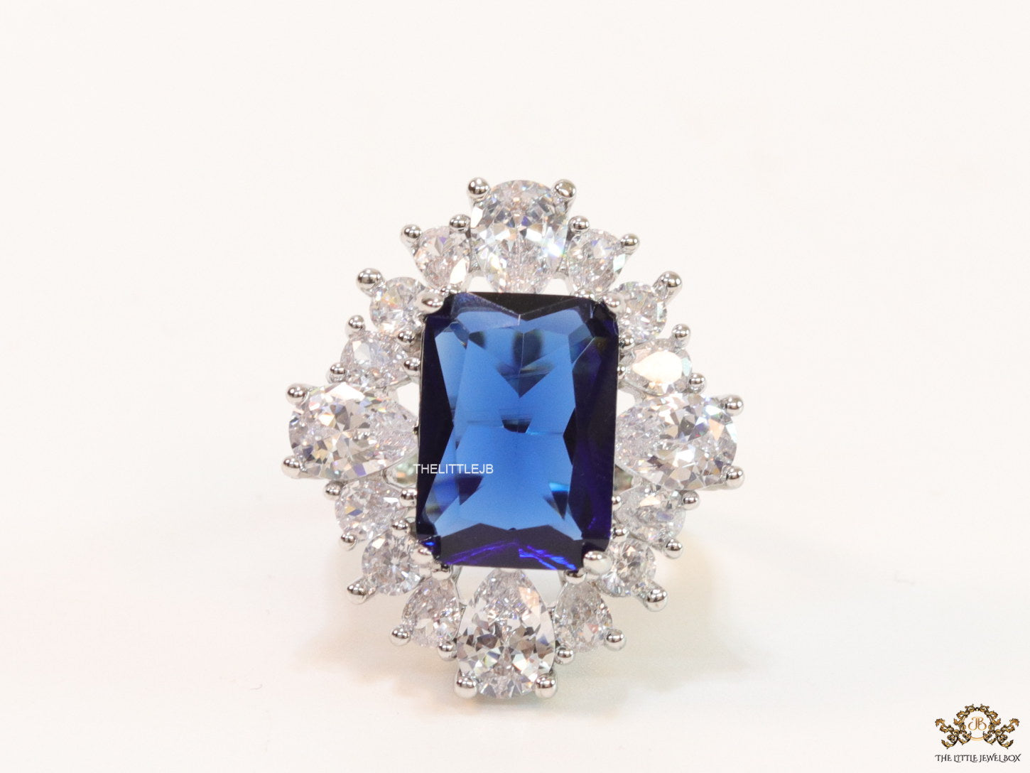 Adjustable sapphire blue cz ring in platinum finish