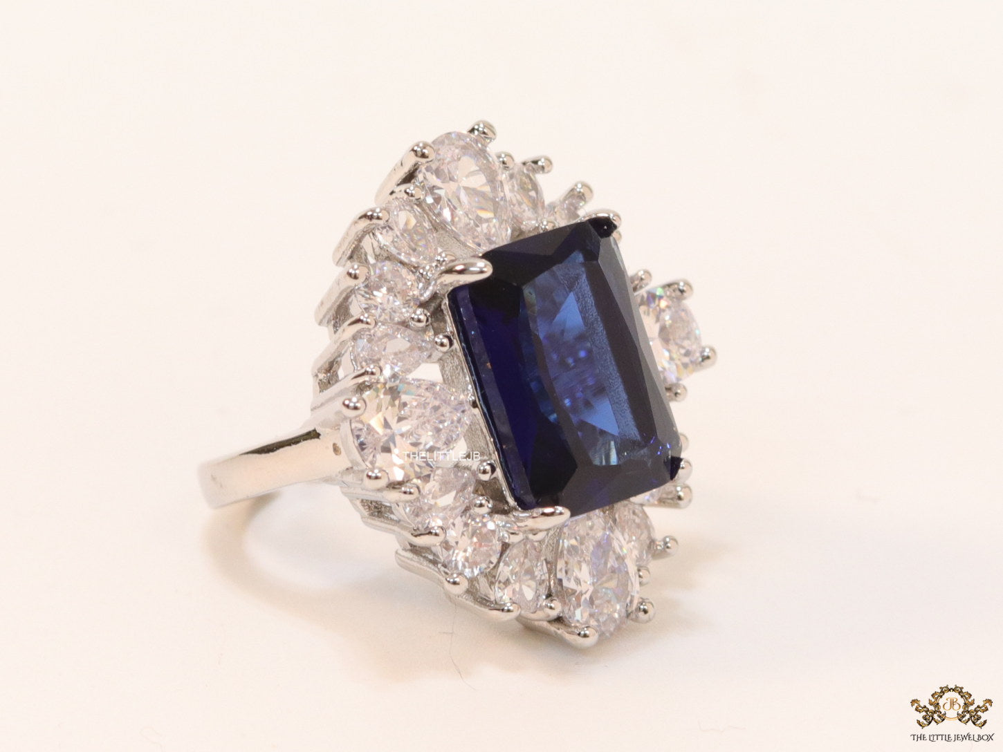 Adjustable sapphire blue cz ring in platinum finish