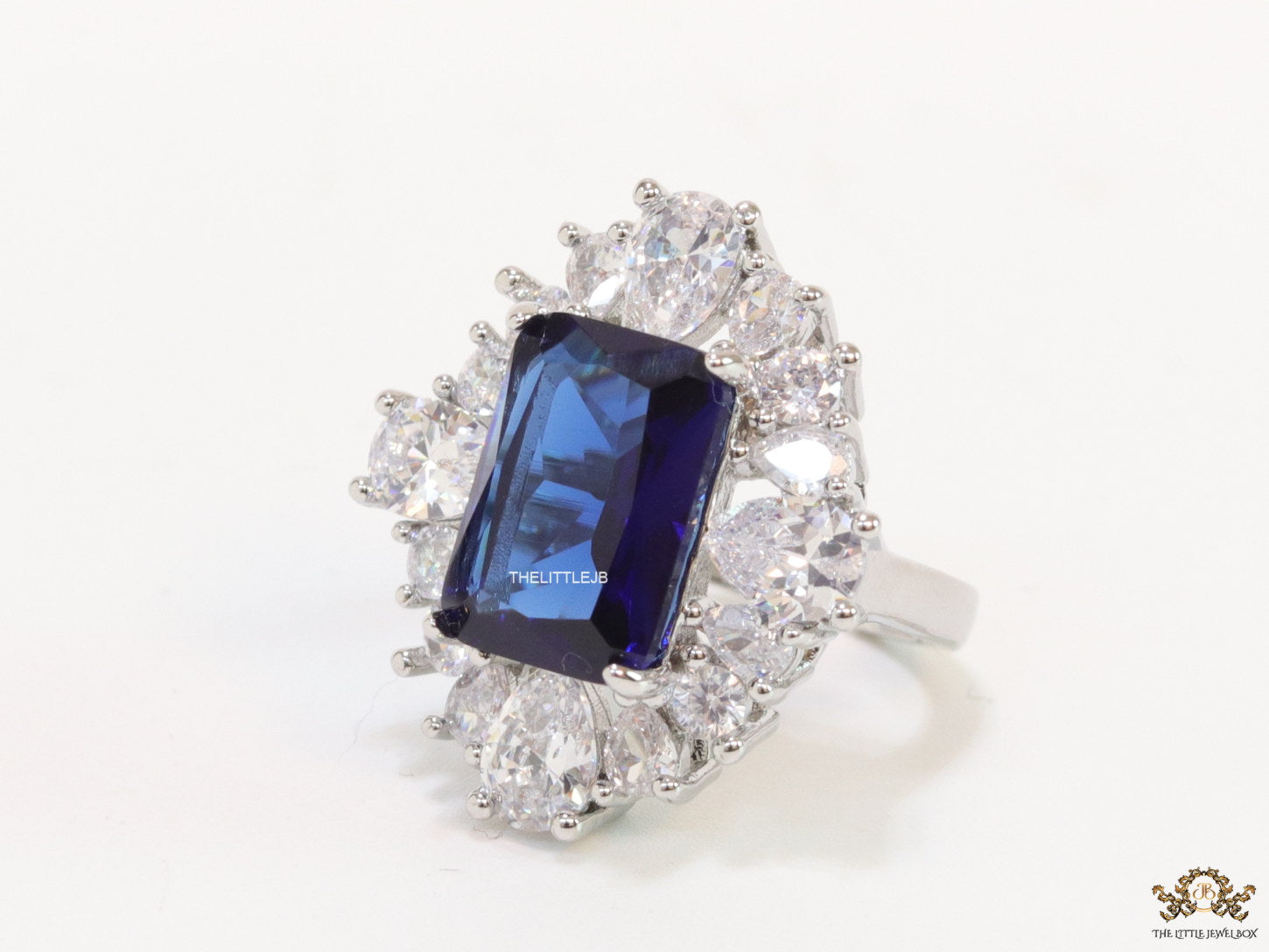 Adjustable sapphire blue cz ring in platinum finish