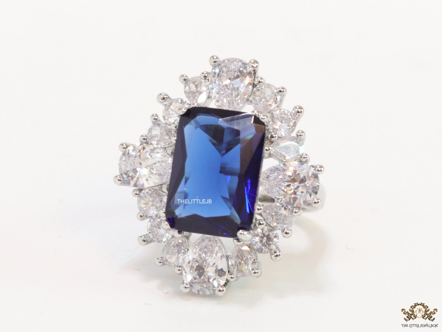Adjustable sapphire blue cz ring in platinum finish