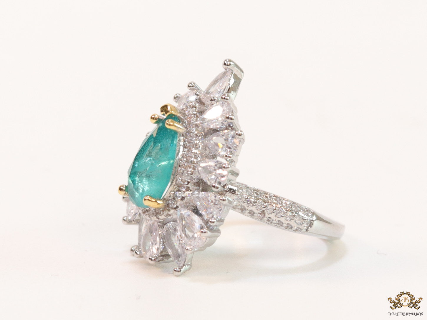 Adjustable drop shape fancy cz ring with green centre and platinum finish