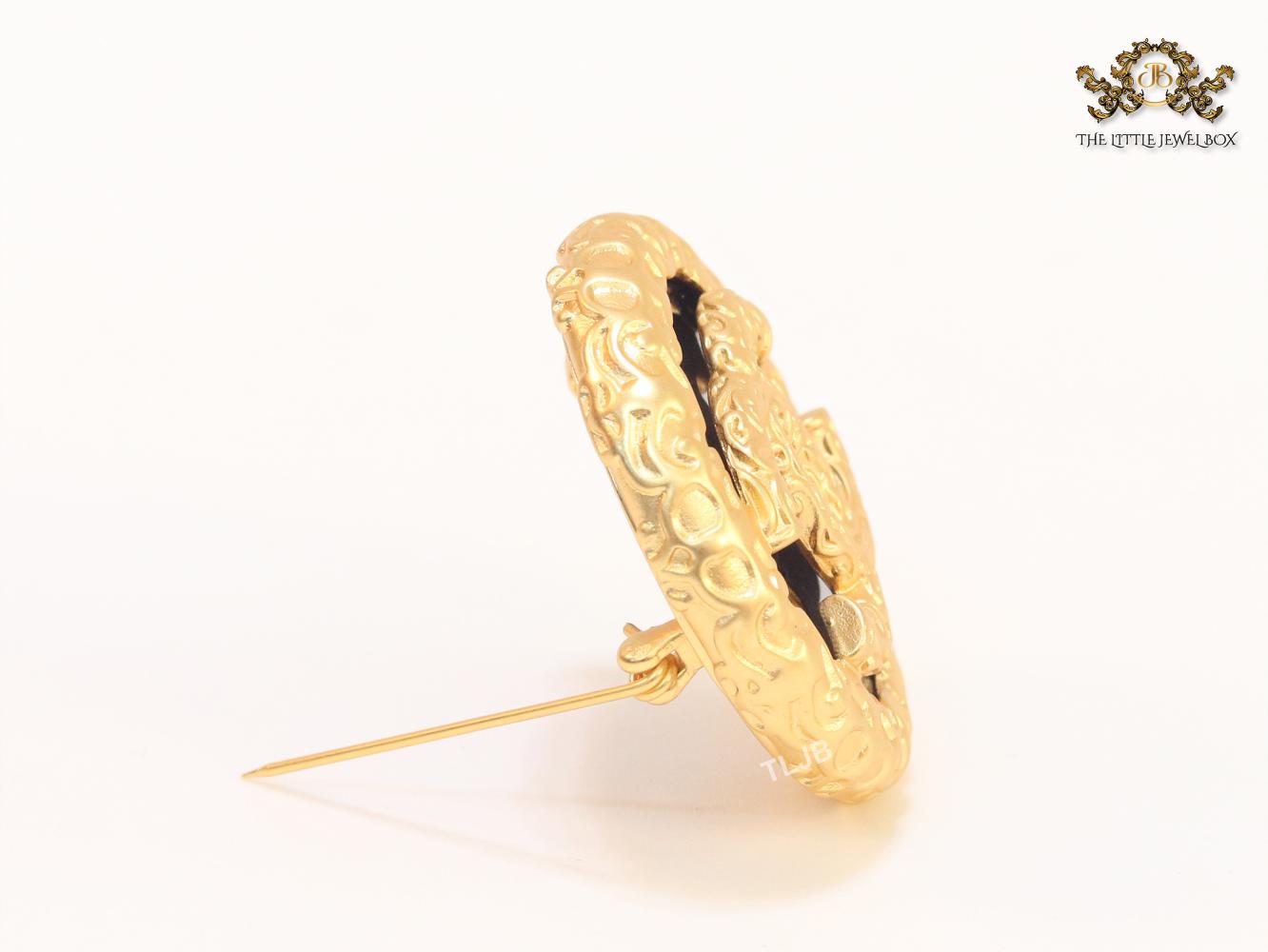 Double C gold foil and black enamel brooch