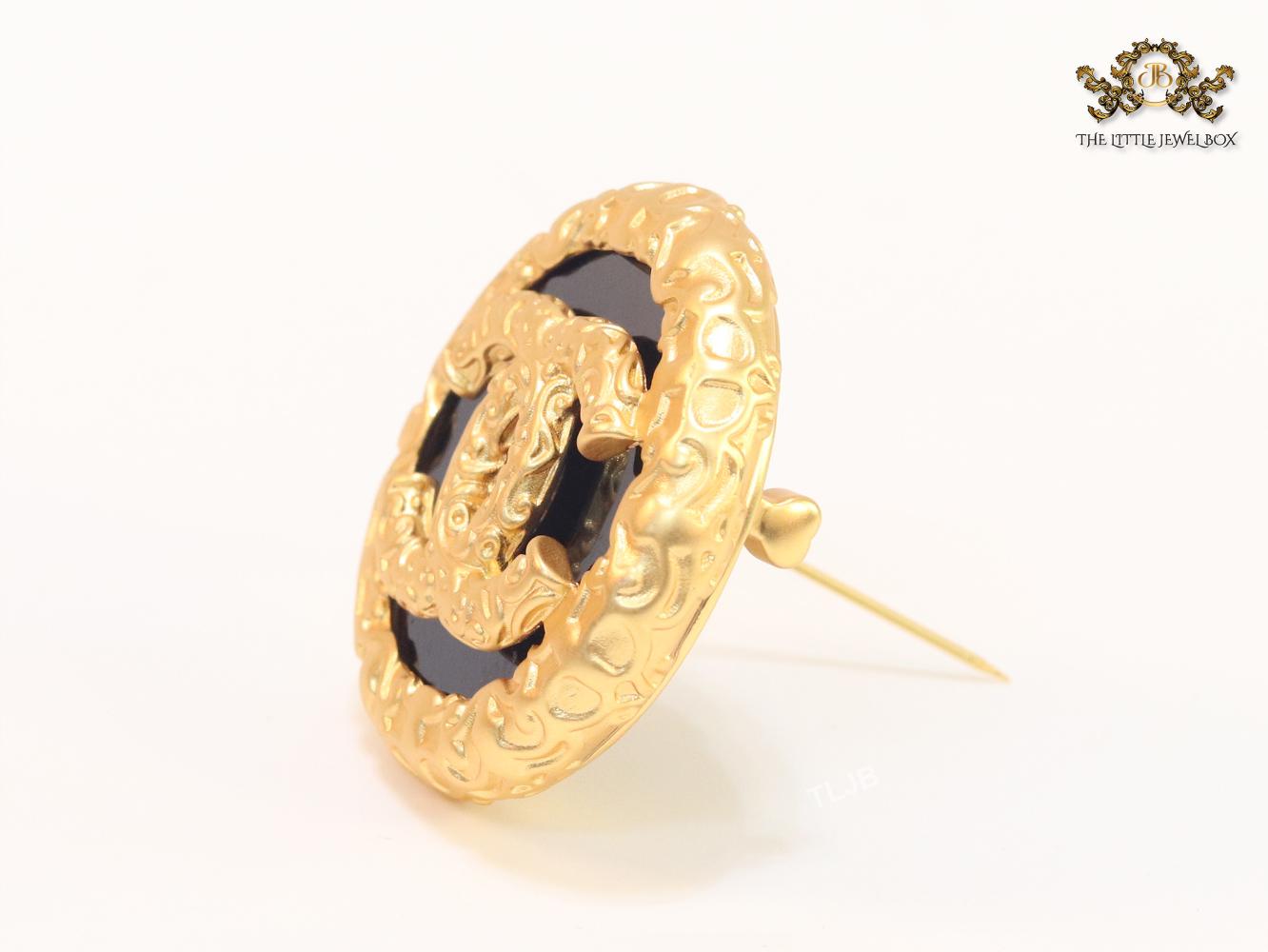 Double C gold foil and black enamel brooch