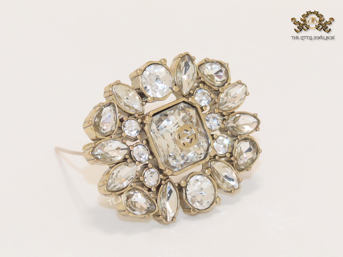 Double G brooch with uncut stones